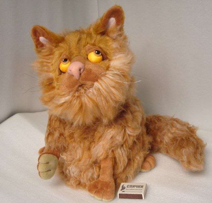 Persian cat stuffed animal, ginger Custom Persian cat stuffed animal made in 2010: ginger faux fur, yellow eyes, a paw raised by a matchbox