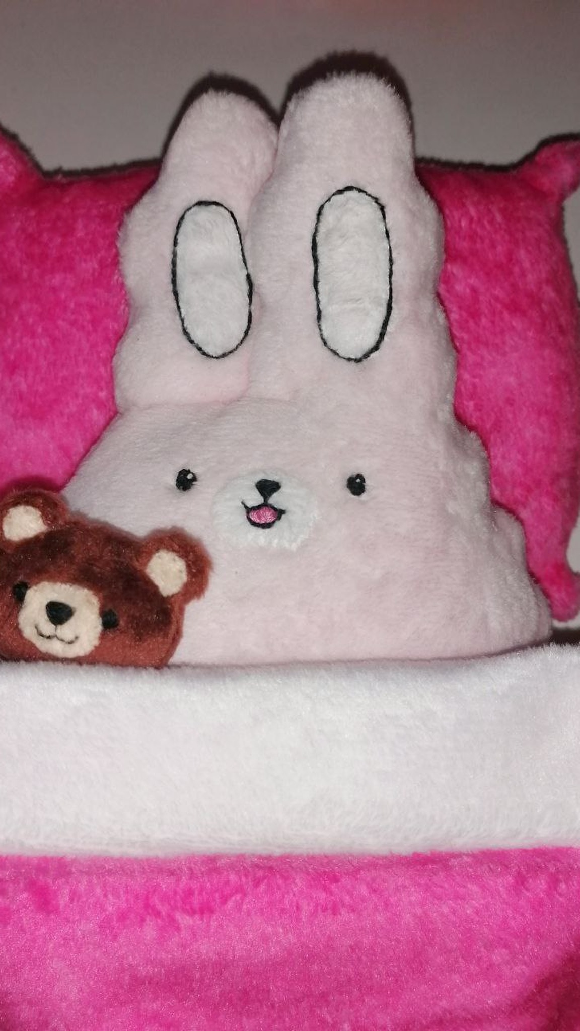 Pink bunny sticker plush tucked into a hot-pink bed with a little teddy bear, custom toy made to order
