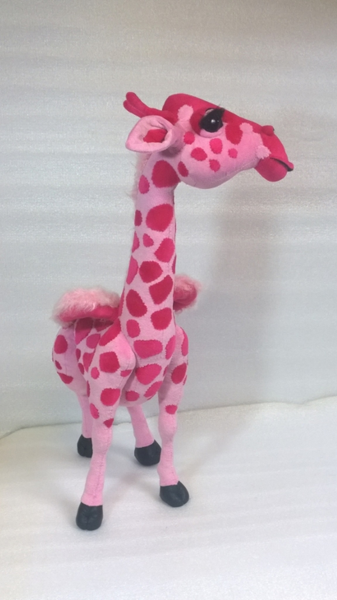 Pink giraffe plush with wings made to order, long spotted neck and raspberry ossicones, sewn from a drawing