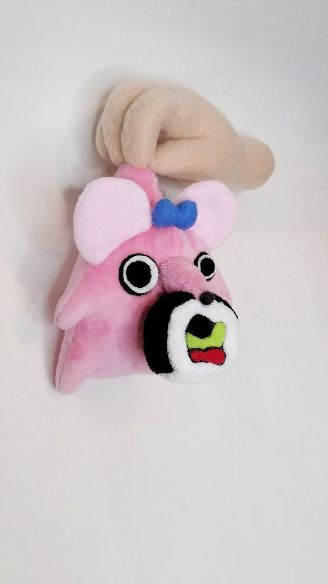 Pink mouse plush with a blue bow and a sushi roll in its mouth, sewn by hand to order from a sticker