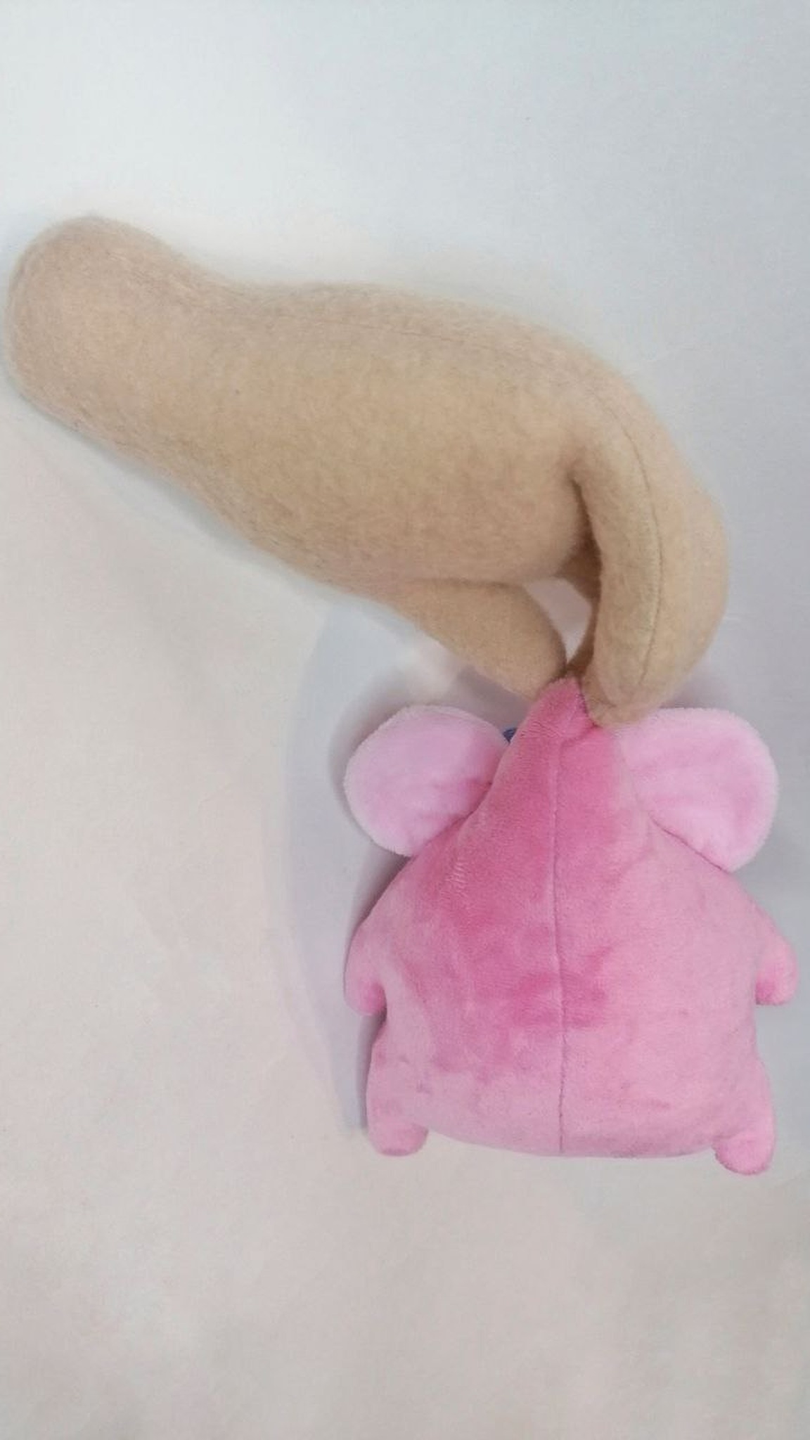 Pink mouse sticker plush with round ears, held up by a beige fleece plush hand, handmade to order
