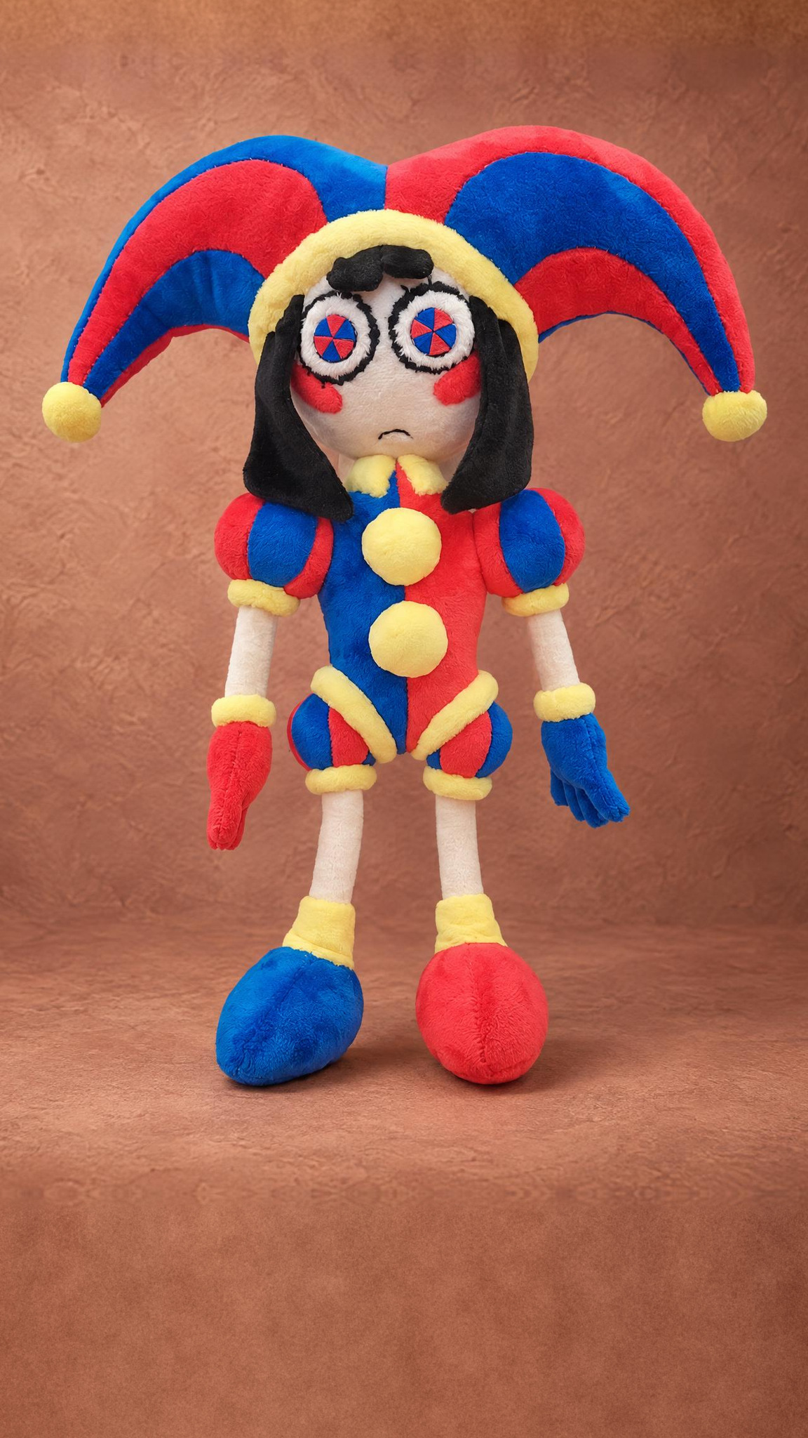 Handmade Pomni plush doll with pinwheel felt eyes, red cheeks and mismatched red and blue shoes, made to order