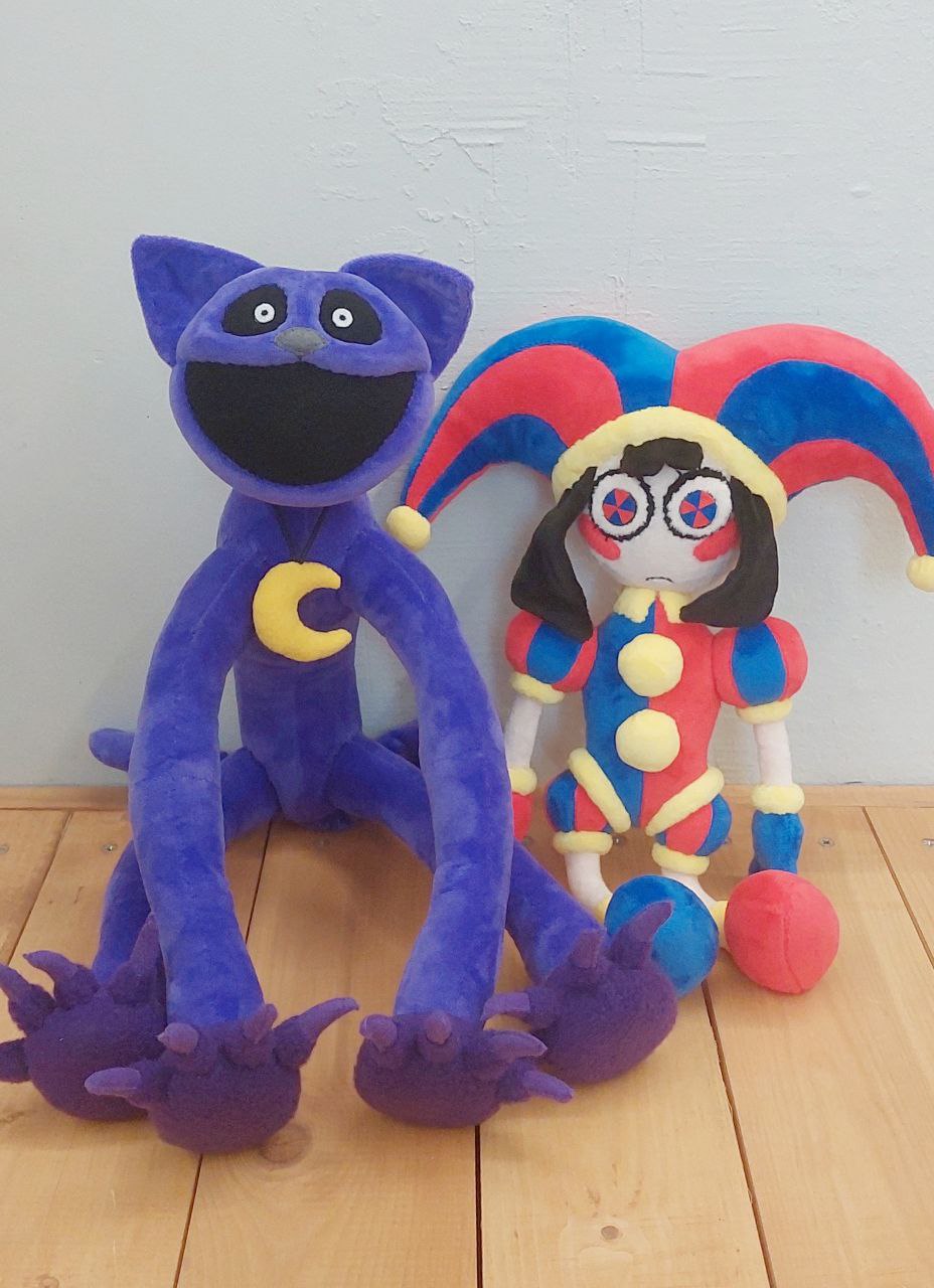 Pomni plush next to a CatNap plush Custom Pomni plush from The Amazing Digital Circus sitting next to a purple CatNap plush, both sewn to order