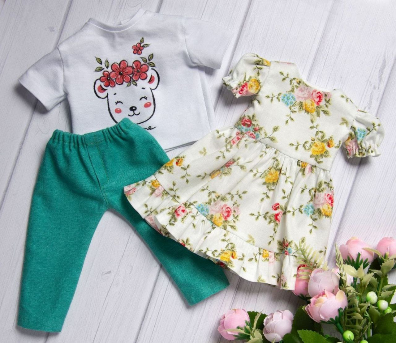 Two outfits sewn for a girl portrait doll Two outfits for a custom girl doll: rose-print dress, bear T-shirt and teal pants, sewn as the customer asked