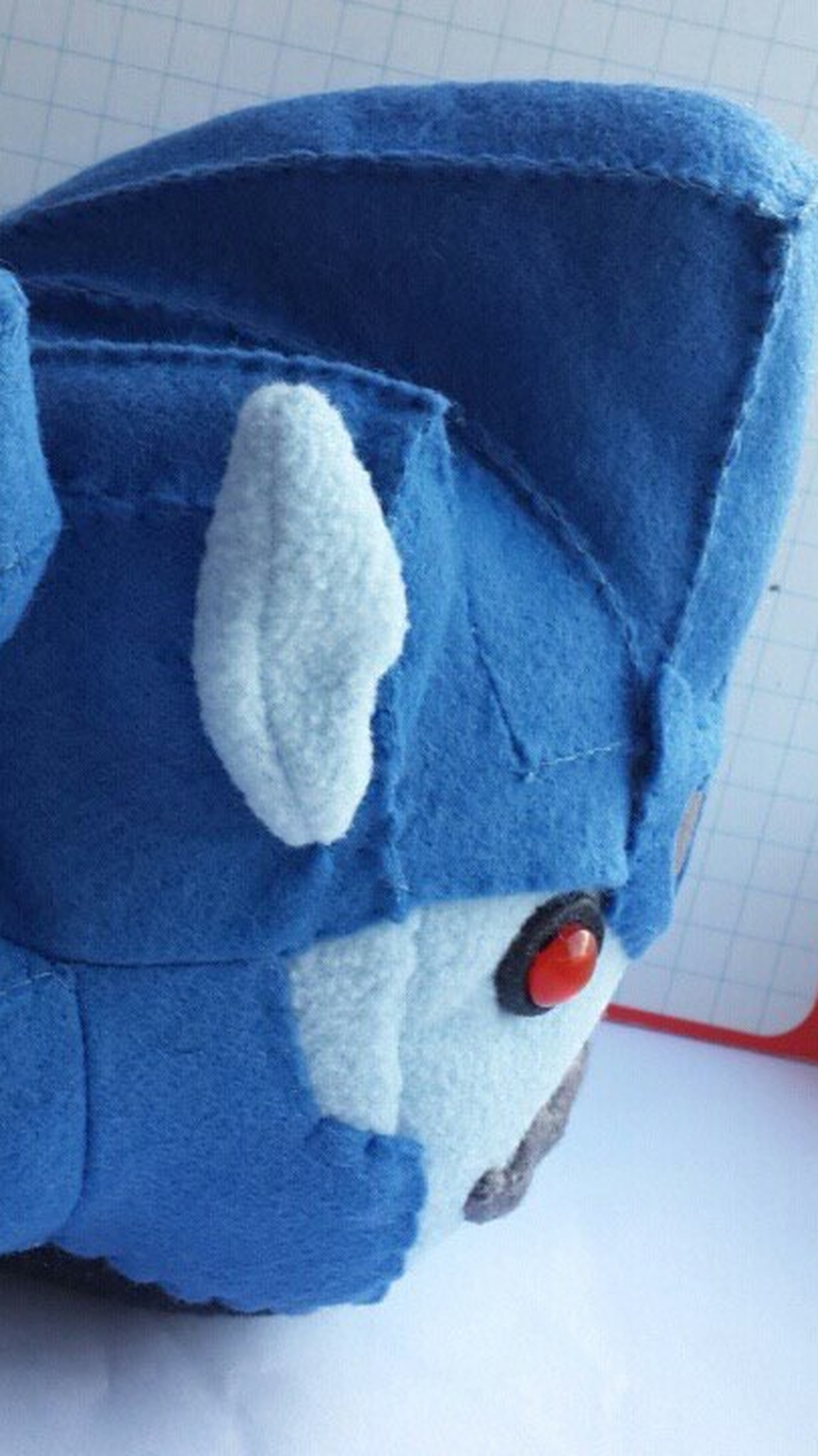 Custom Transformers plush: blue felt helmet fin, fleece pug ear and a red eye, sewn by hand to order