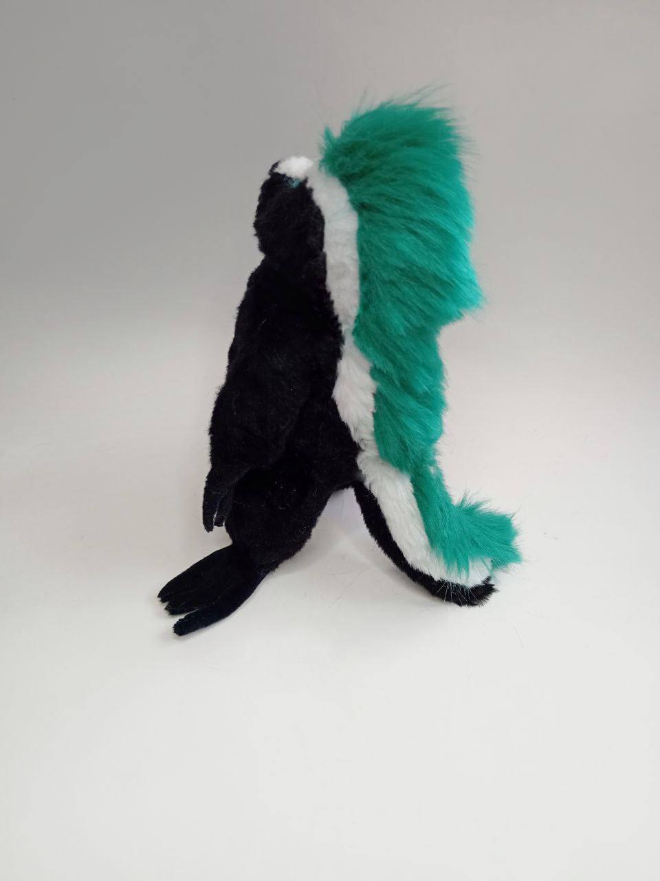 Punk honey badger plush, mohawk and tail Punk honey badger plush from behind: white stripe and teal mohawk ending in a fluffy tail, made to order