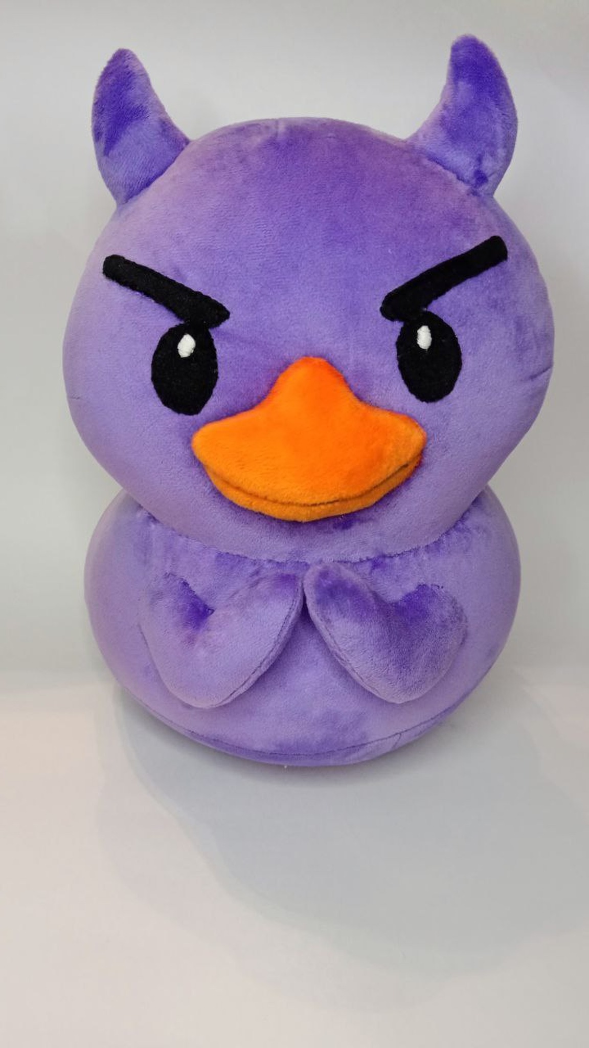 Purple devil duck plush with horns and folded wings, sewn to order from a messenger sticker