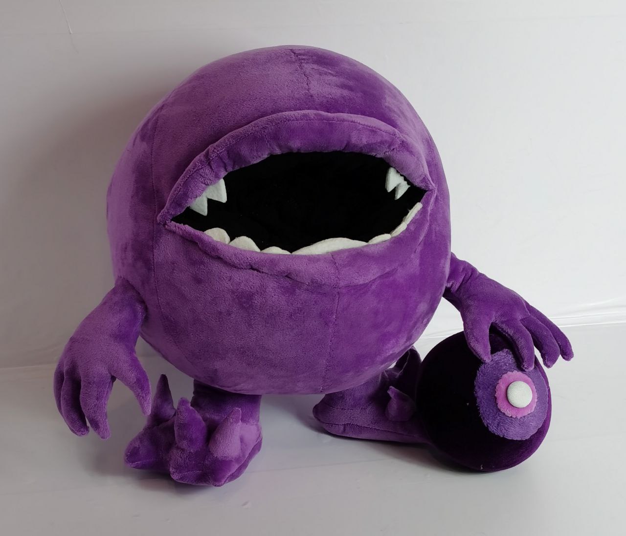 Monster plush with a removable ball Purple monster plush holding the ball taken out of its mouth, a removable part of this custom handmade toy