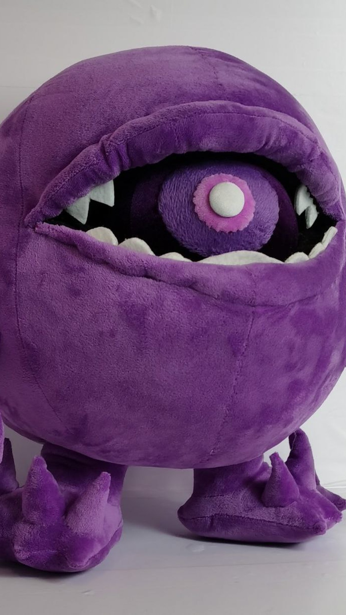 Purple monster plush Fiobol with white pointed teeth and a wide open mouth, handmade custom plush