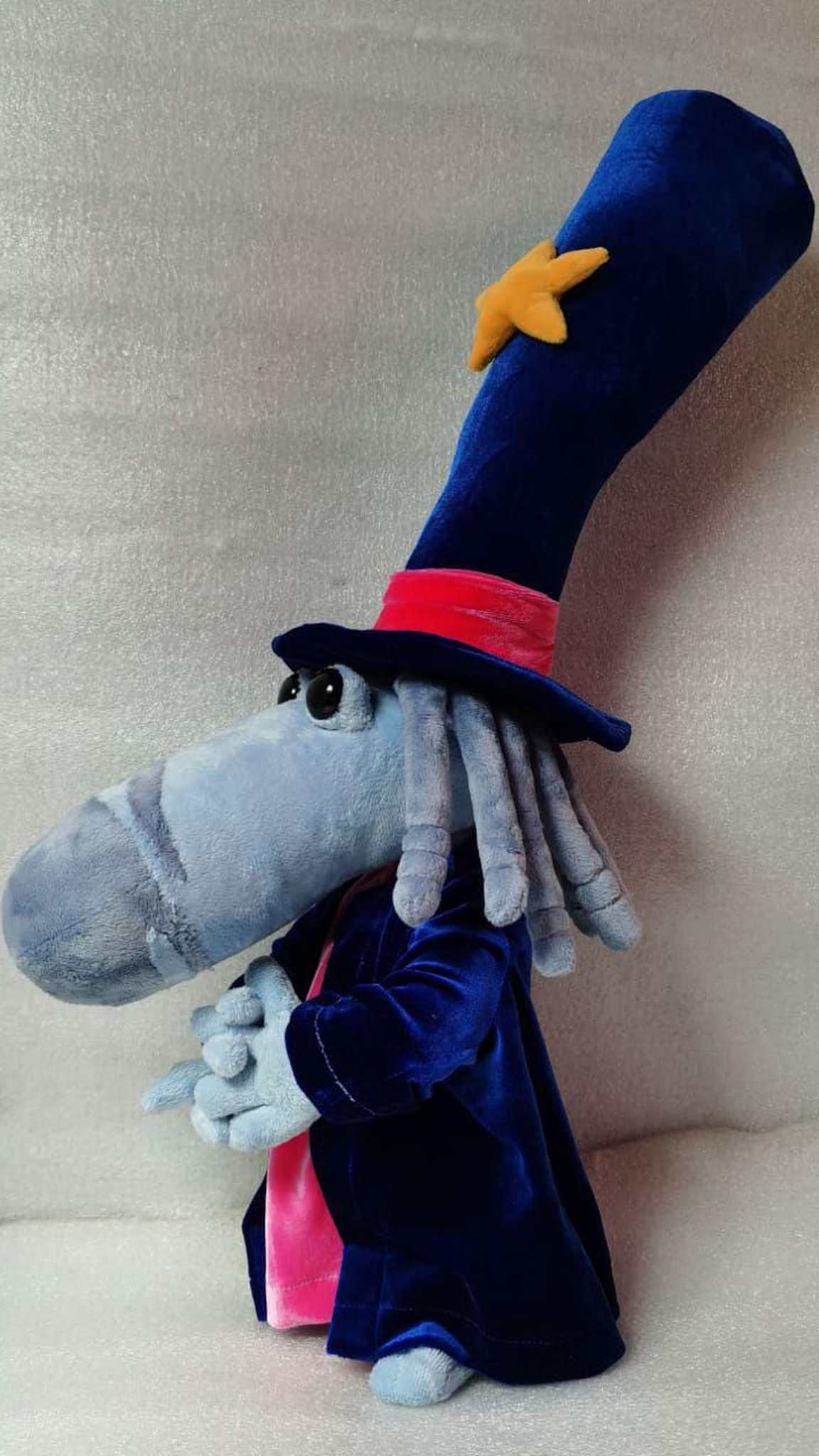 Handmade Rayman Magician plush with grey-blue yarn hair and a pink band on his tall velvet star hat, made to order