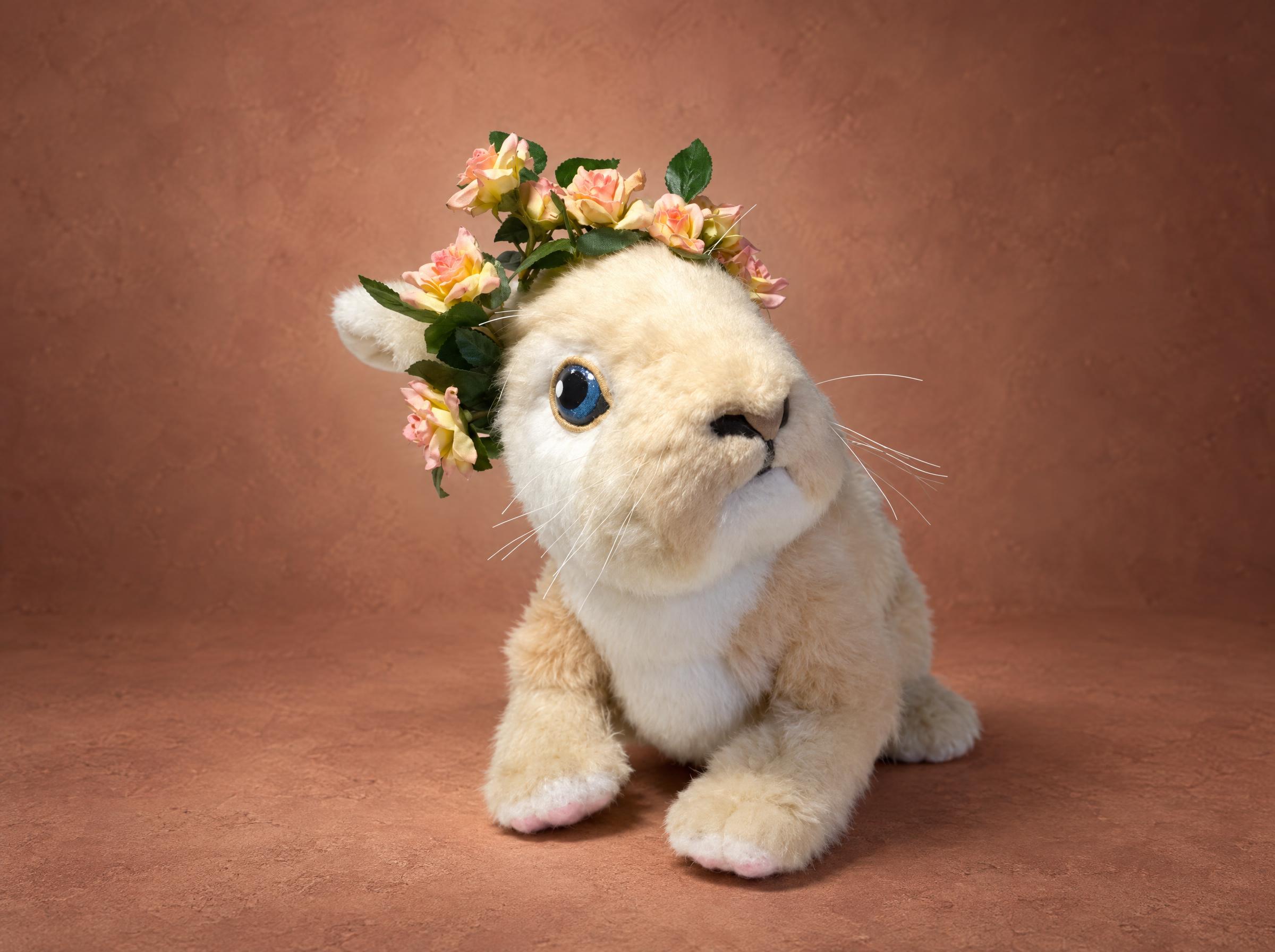 Realistic bunny plush in cream faux fur with blue eyes and a crown of pink roses, handmade to order