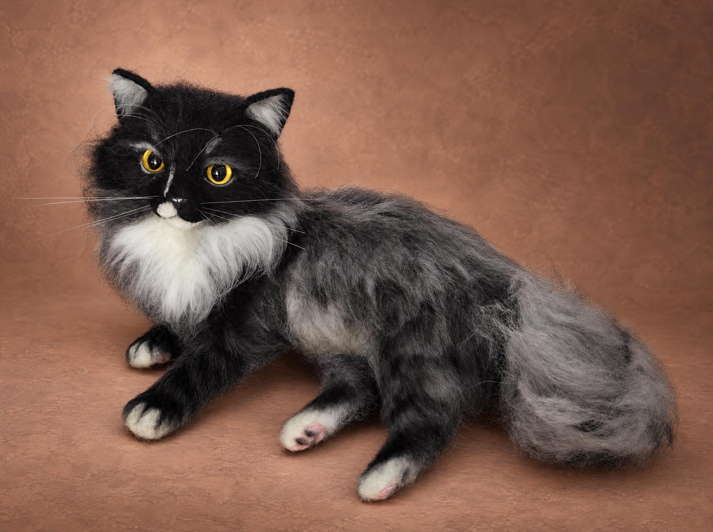 Realistic fluffy cat plush in smoky grey faux fur with a black face, white bib and amber eyes, made to order
