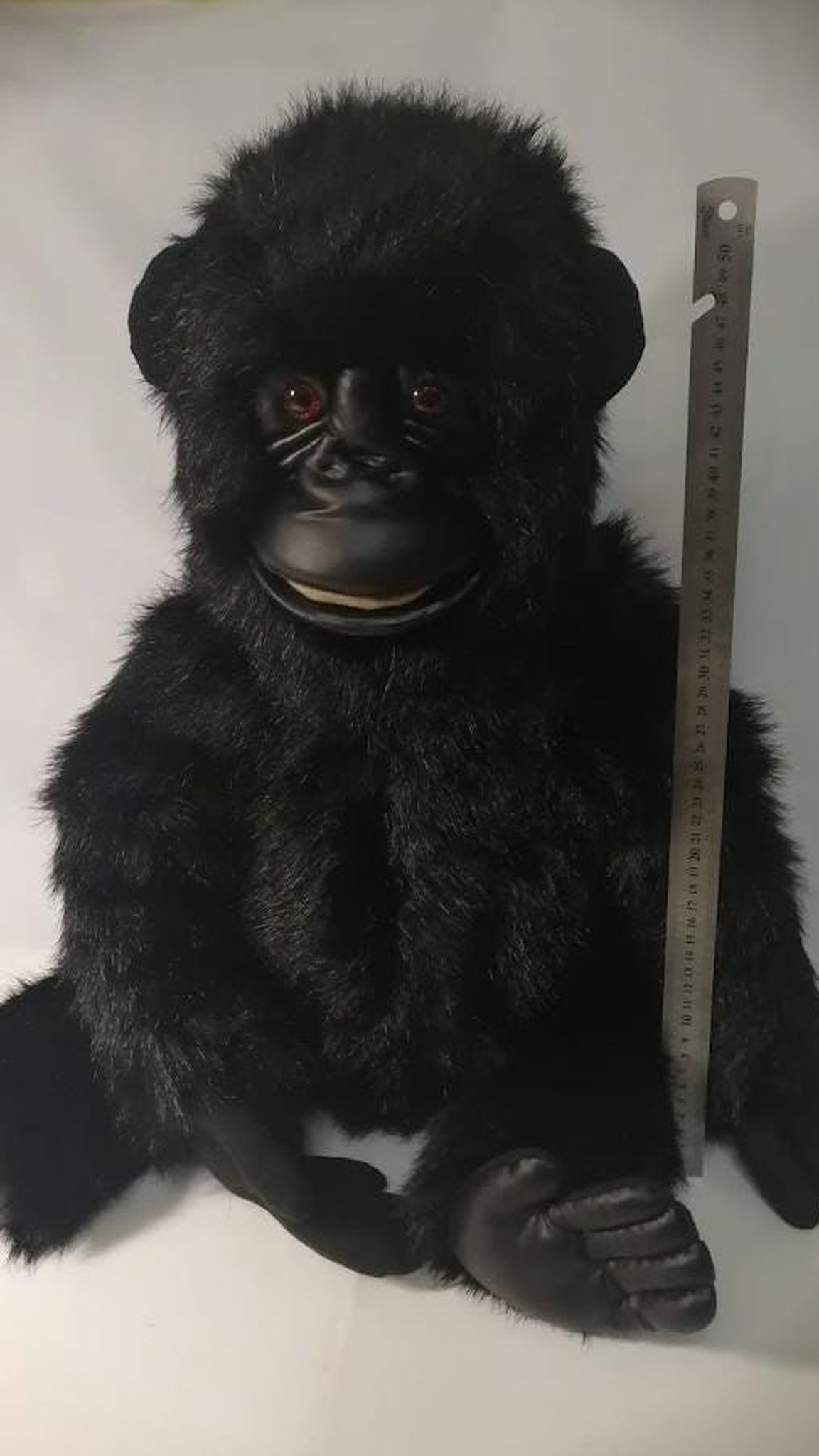 Handmade gorilla plush next to a ruler: realistic baby gorilla about 55 cm tall in black faux fur, made to order