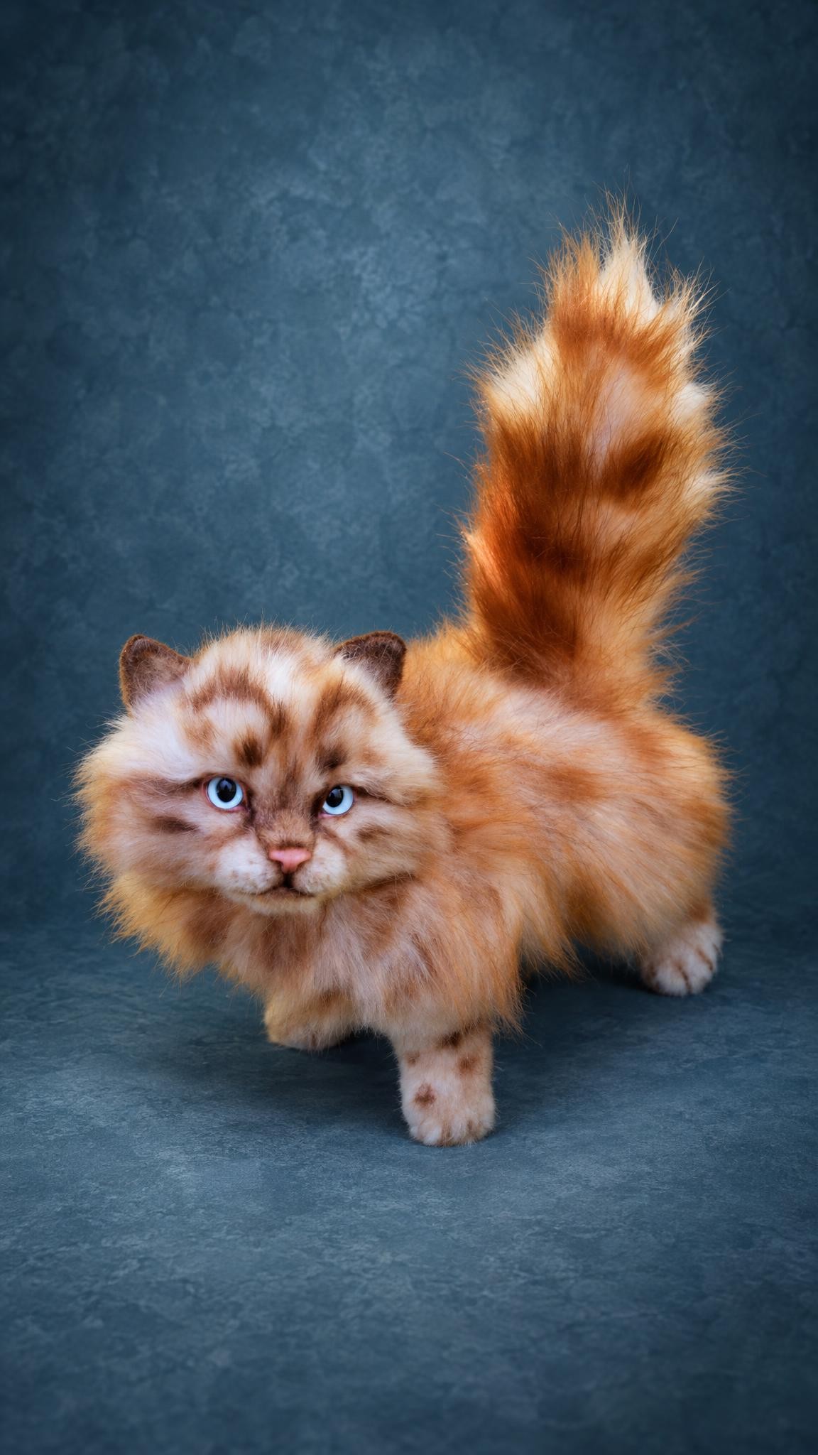 Custom ginger kitten plush with brown spots, blue eyes and a bushy tail, sewn by hand to order
