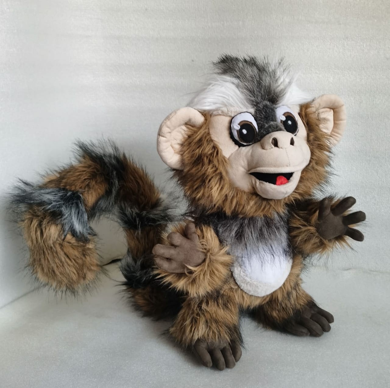 Marmoset monkey plush, tail curled Marmoset monkey plush with its striped tail curled behind and a hand on its belly, sewn to order
