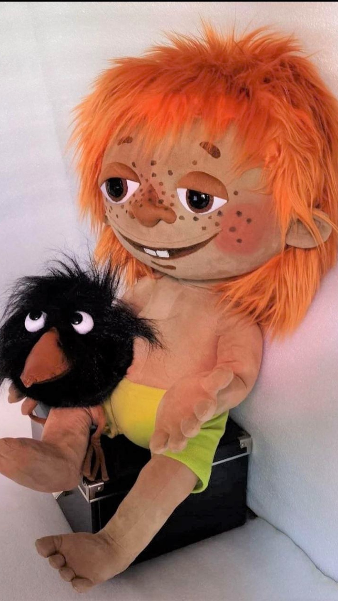 Red-haired boy doll Antoshka grinning, a shaggy black crow on his lap, Soviet cartoon doll made to order
