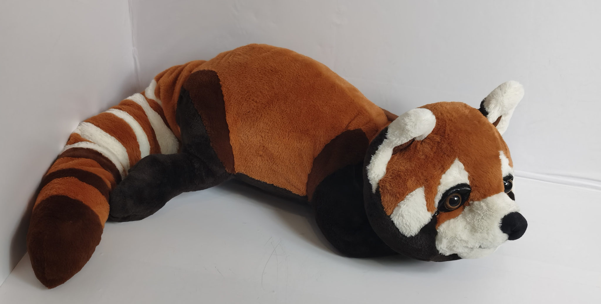 Red panda plush toy with a ringed tail Red panda plush toy made to order, its long ringed tail curving around dark brown back paws