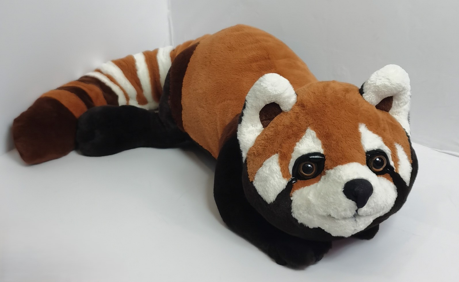 Red panda stuffed animal with amber eyes Red panda stuffed animal sewn to order, with cream cheeks, tear marks and amber eyes on a rusty orange head