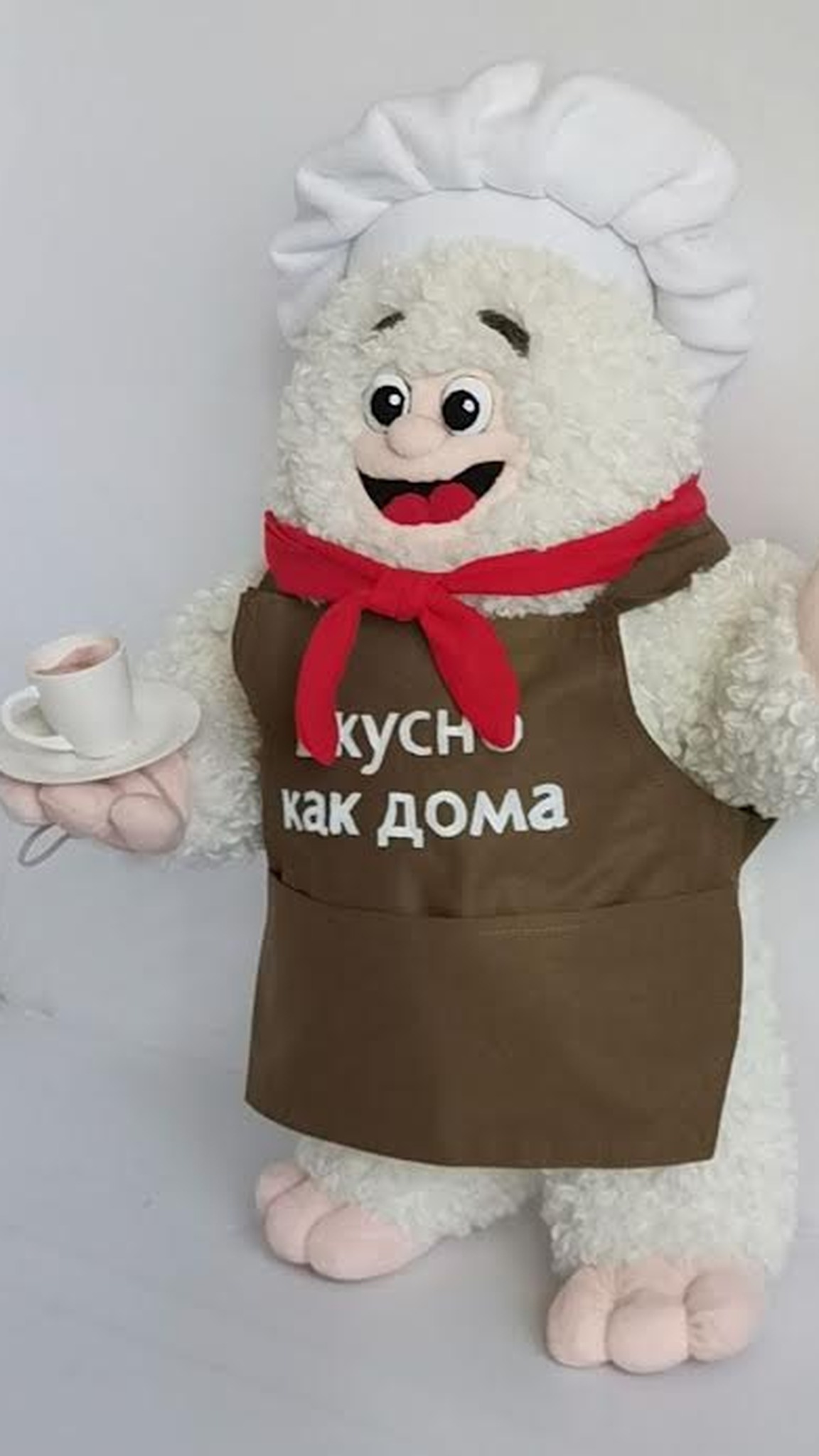 Restaurant mascot plush: curly white chef in a red neckerchief and brown apron holding a teacup, made to order