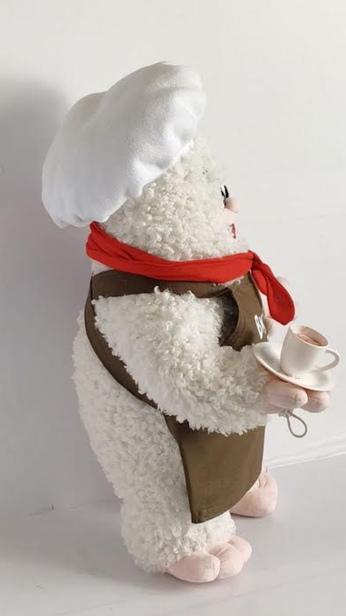 Custom restaurant mascot plush with a teacup on a saucer, white chef hat and curly faux fur, handmade to order