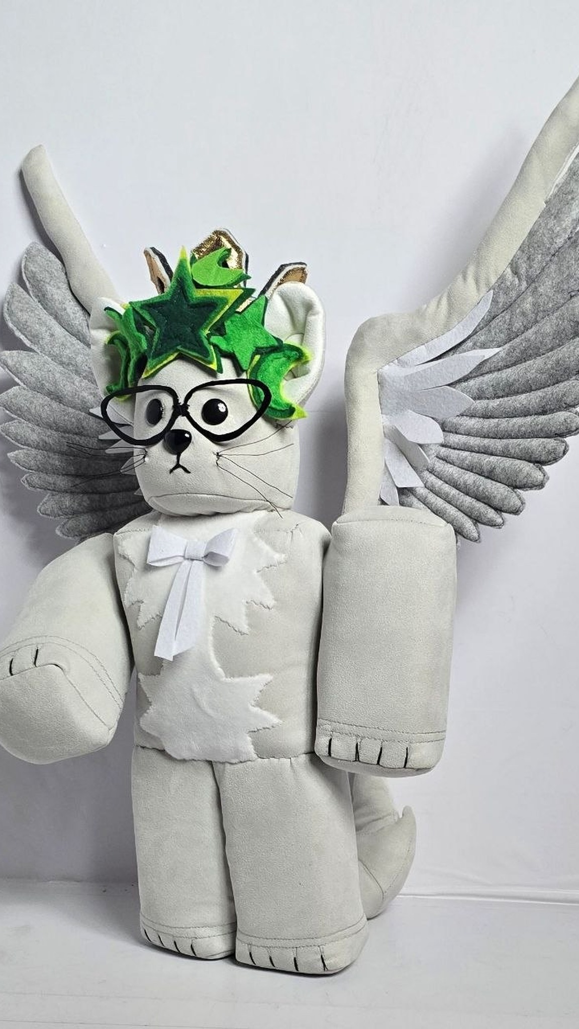 Blocky Roblox cat plush with grey felt wings, heart-shaped glasses and bow tie, a handmade custom avatar toy