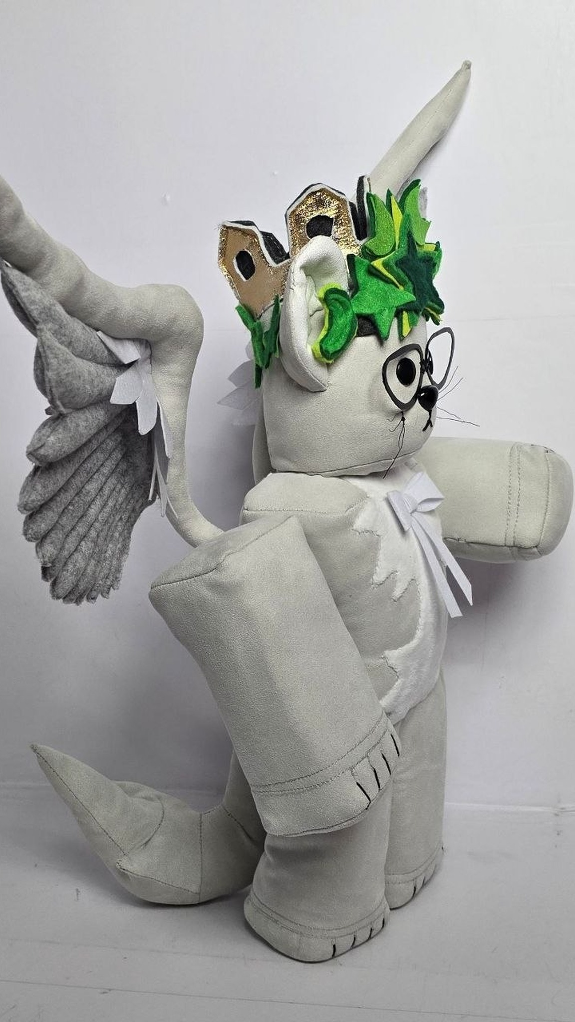Custom Roblox angel cat plush with gold crown points behind green stars and a long pointed tail, sewn to order