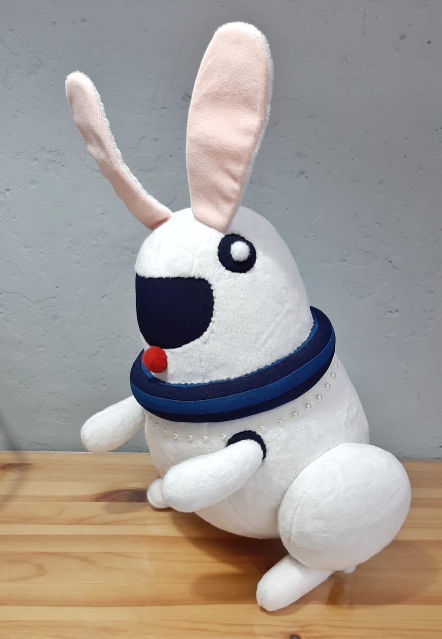 White robot bunny plush with a navy collar White robot bunny plush with a red pompom nose and navy collar ring, sewn from a vector picture
