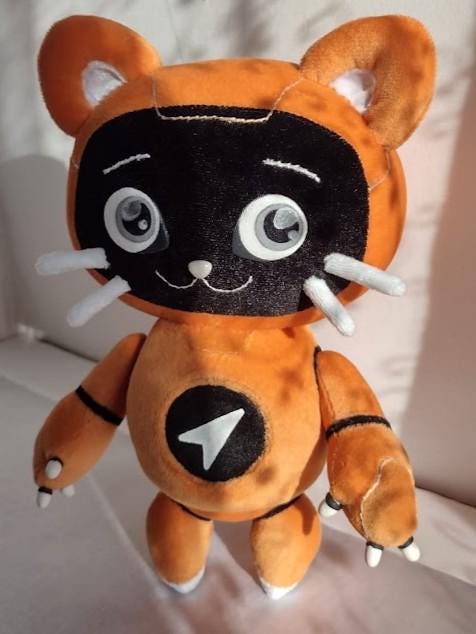 Robot cat plush with black visor face Robot cat plush with a black visor, big grey eyes, stitched smile and a logo on the chest, custom mascot