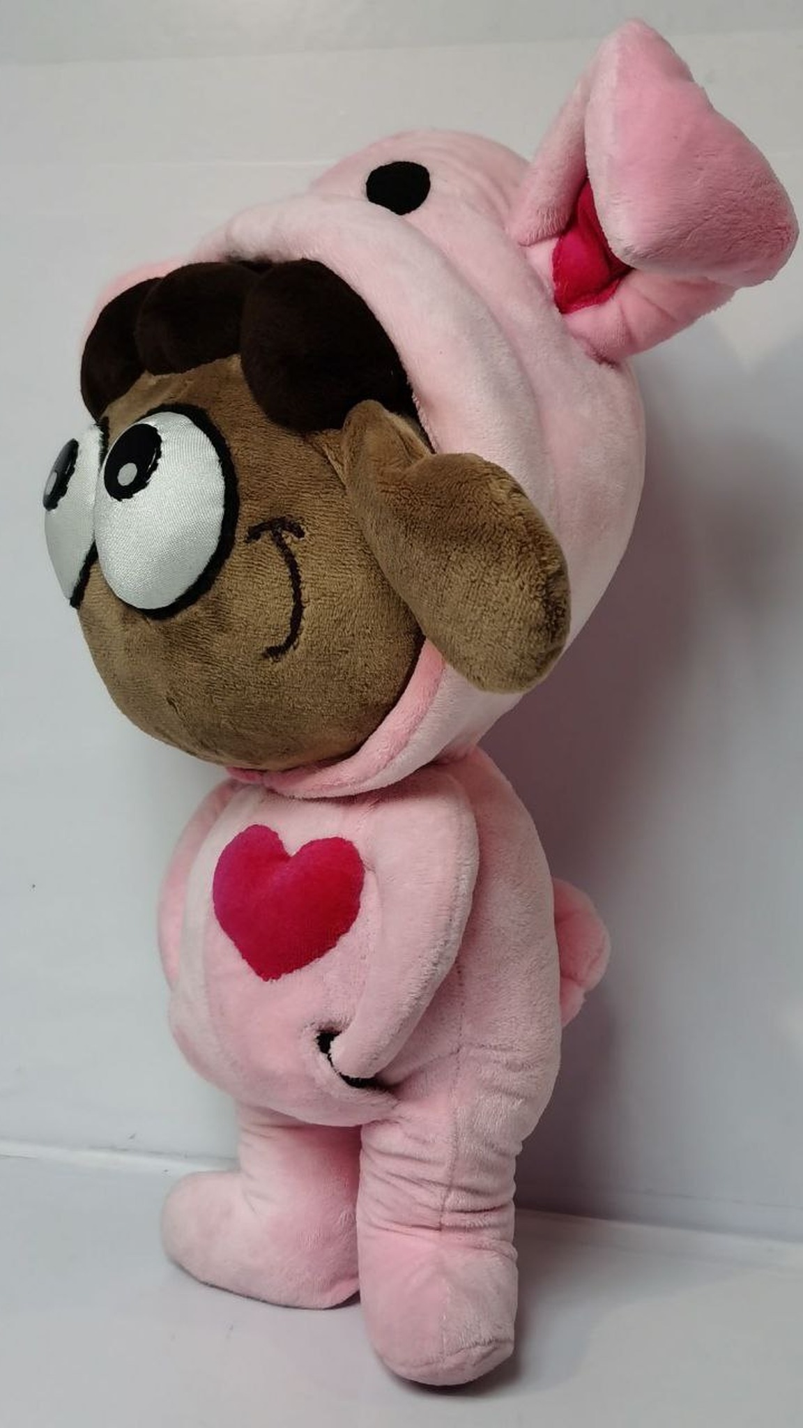 Sheep plush toy in a pink bunny-ear hood with red lining, brown floppy ear sticking out, custom sticker toy