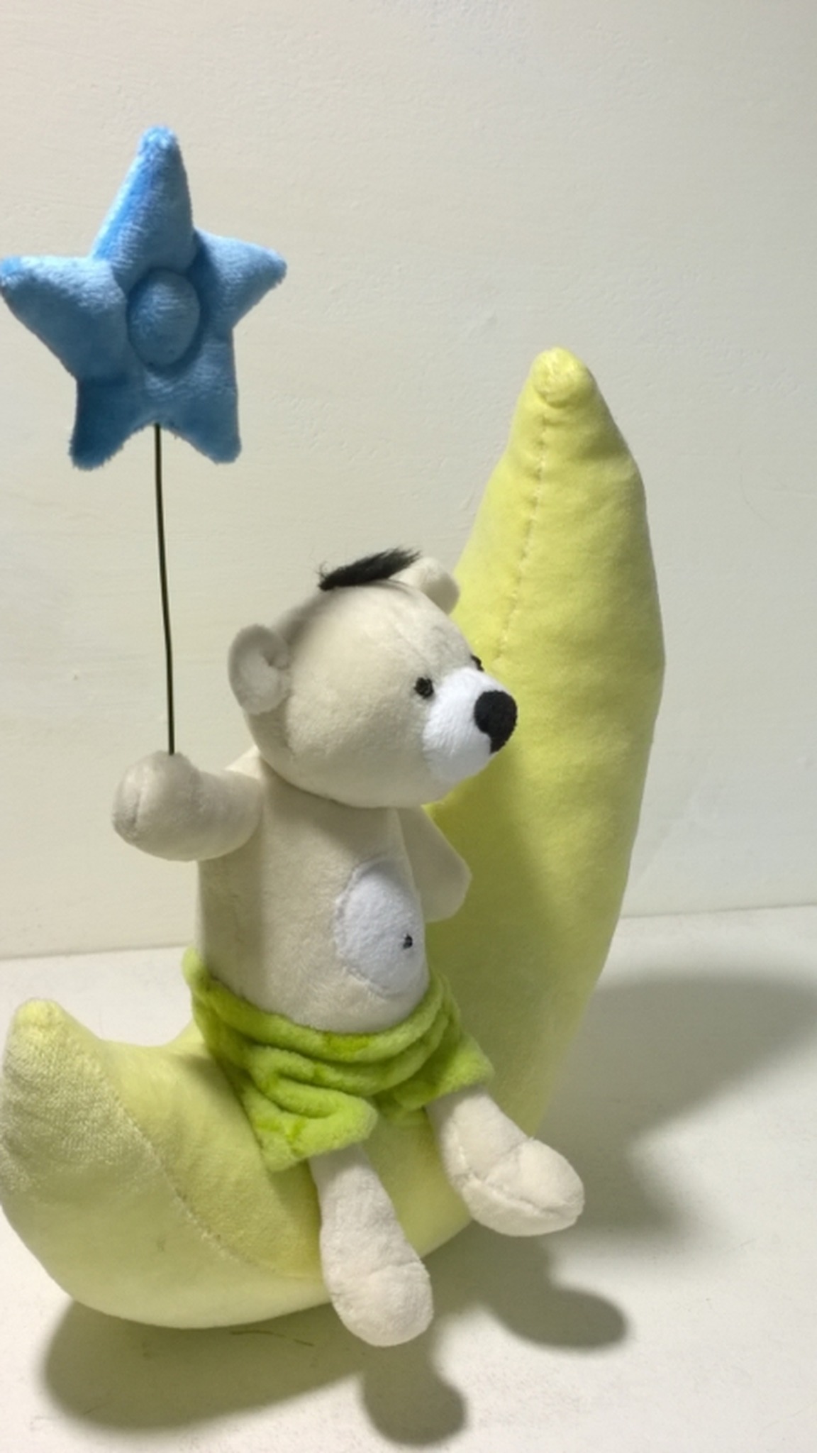 Custom teddy bear plush with a white muzzle and black nose, holding a blue star, sewn to order from a drawing