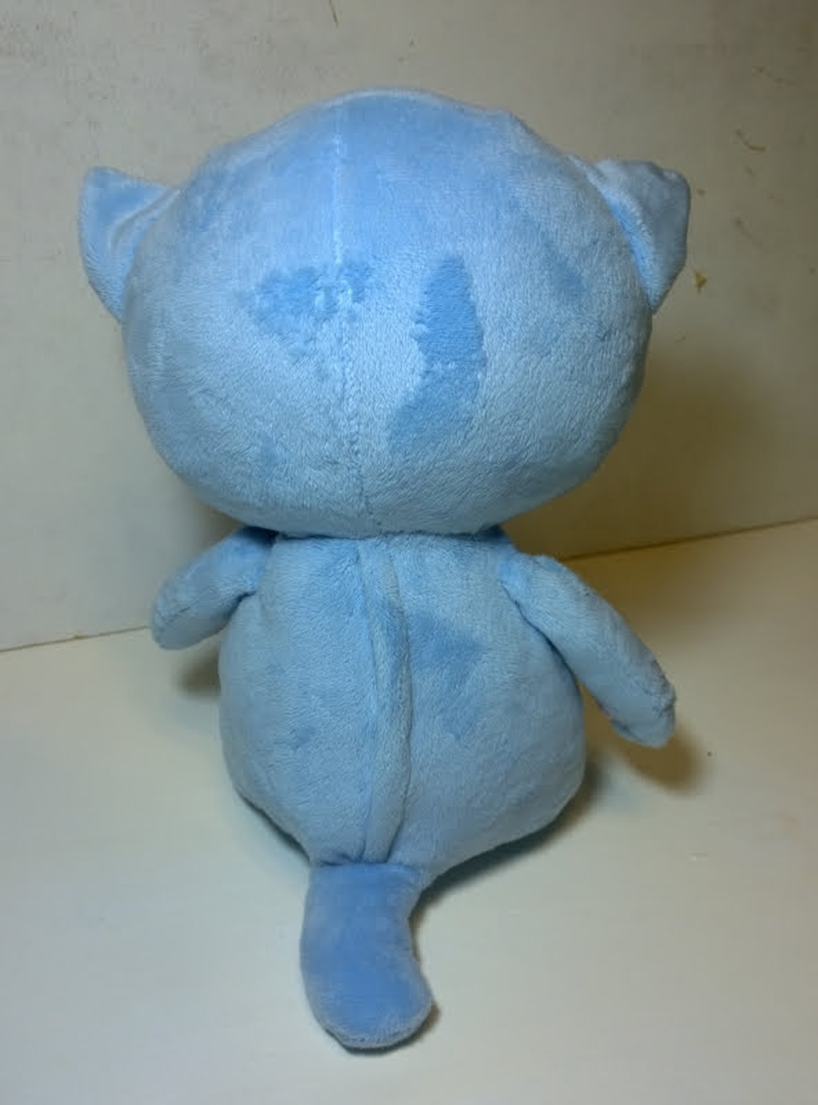 Blue sleepy kitten plush with a short tail Back of the blue sleepy kitten plush with its short tail and round head, handmade anime cat to order