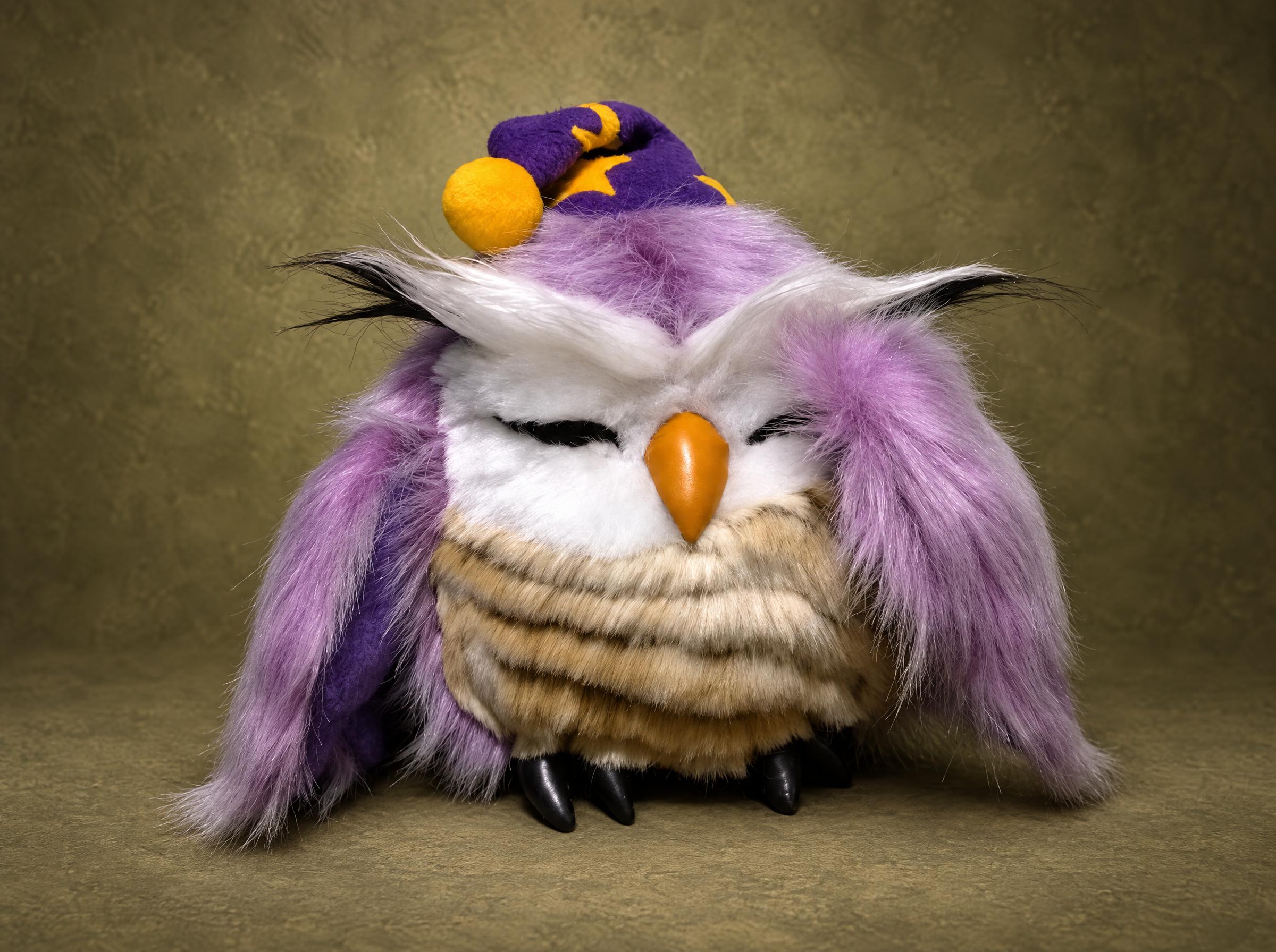 Sleepy owl plush in a purple starry nightcap, lilac faux fur, closed eyes and an orange beak, handmade to order