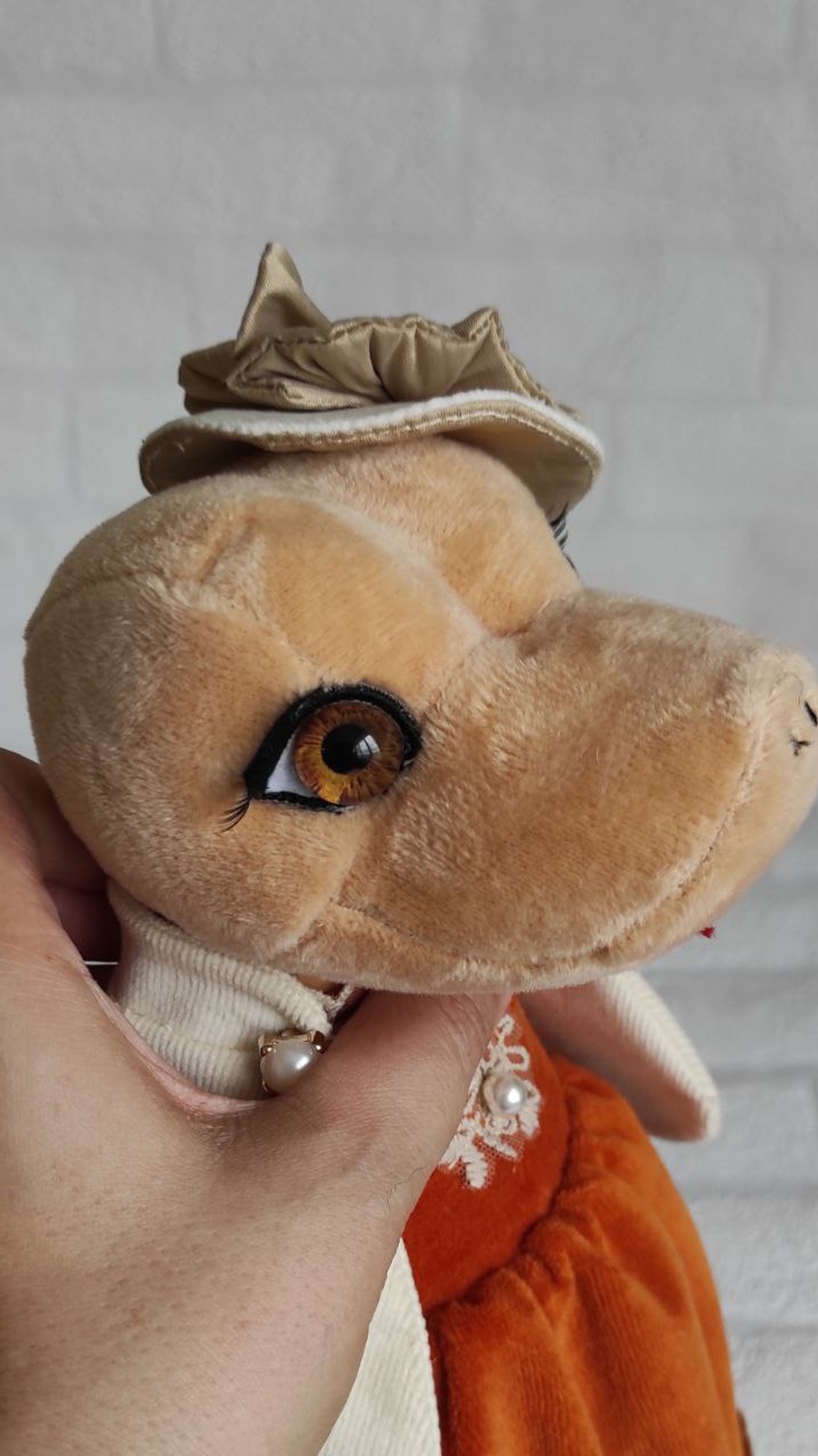 Handmade snake plush with amber eyes and lashes, sewn to order for a company New Year gift