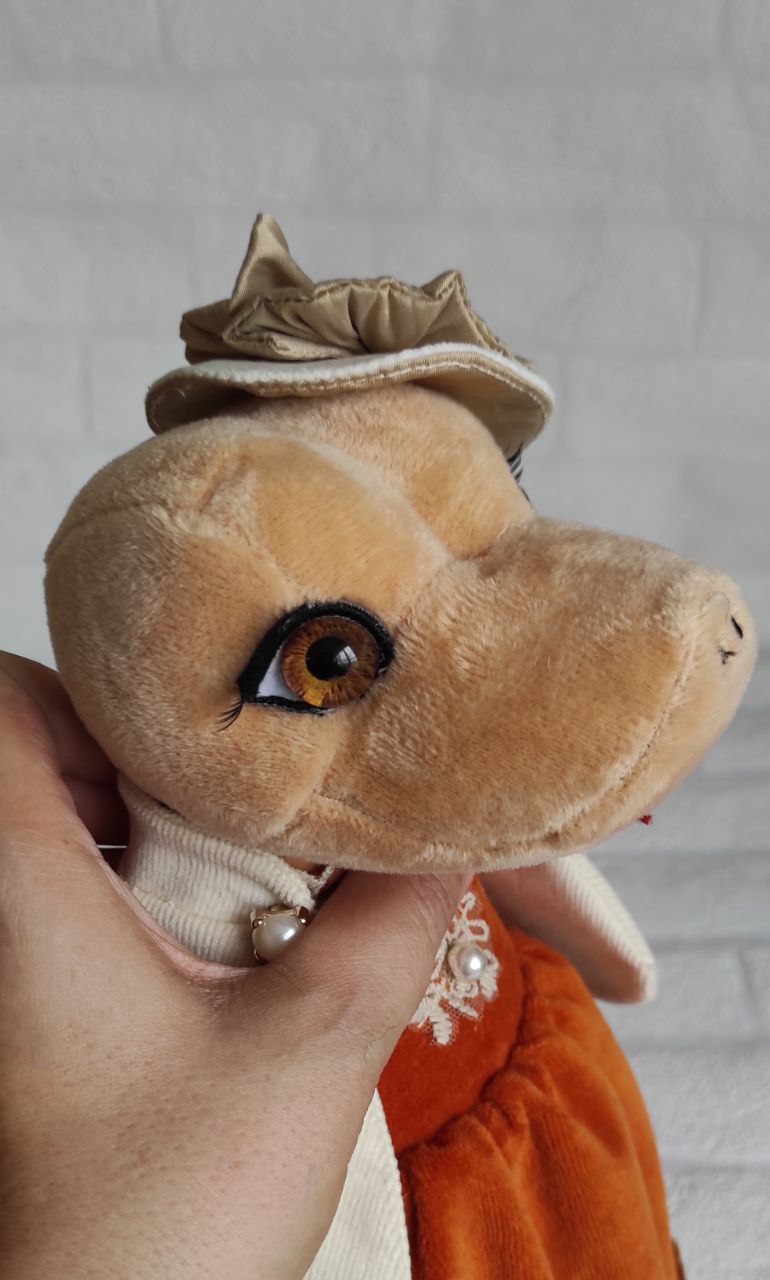 Snake plush with amber eyes Handmade snake plush with amber eyes, long lashes and pearl-trimmed hat, sewn to order as a corporate gift