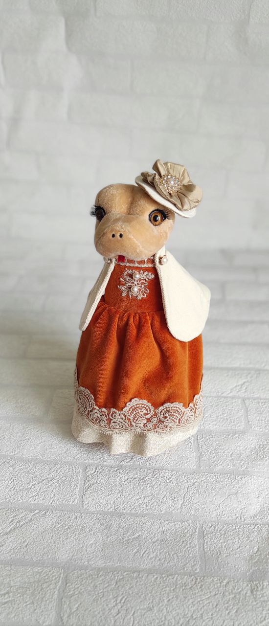 Snake plush lady in velvet dress Snake plush lady in an orange velvet dress with lace hem and satin flower hat, handmade corporate gift