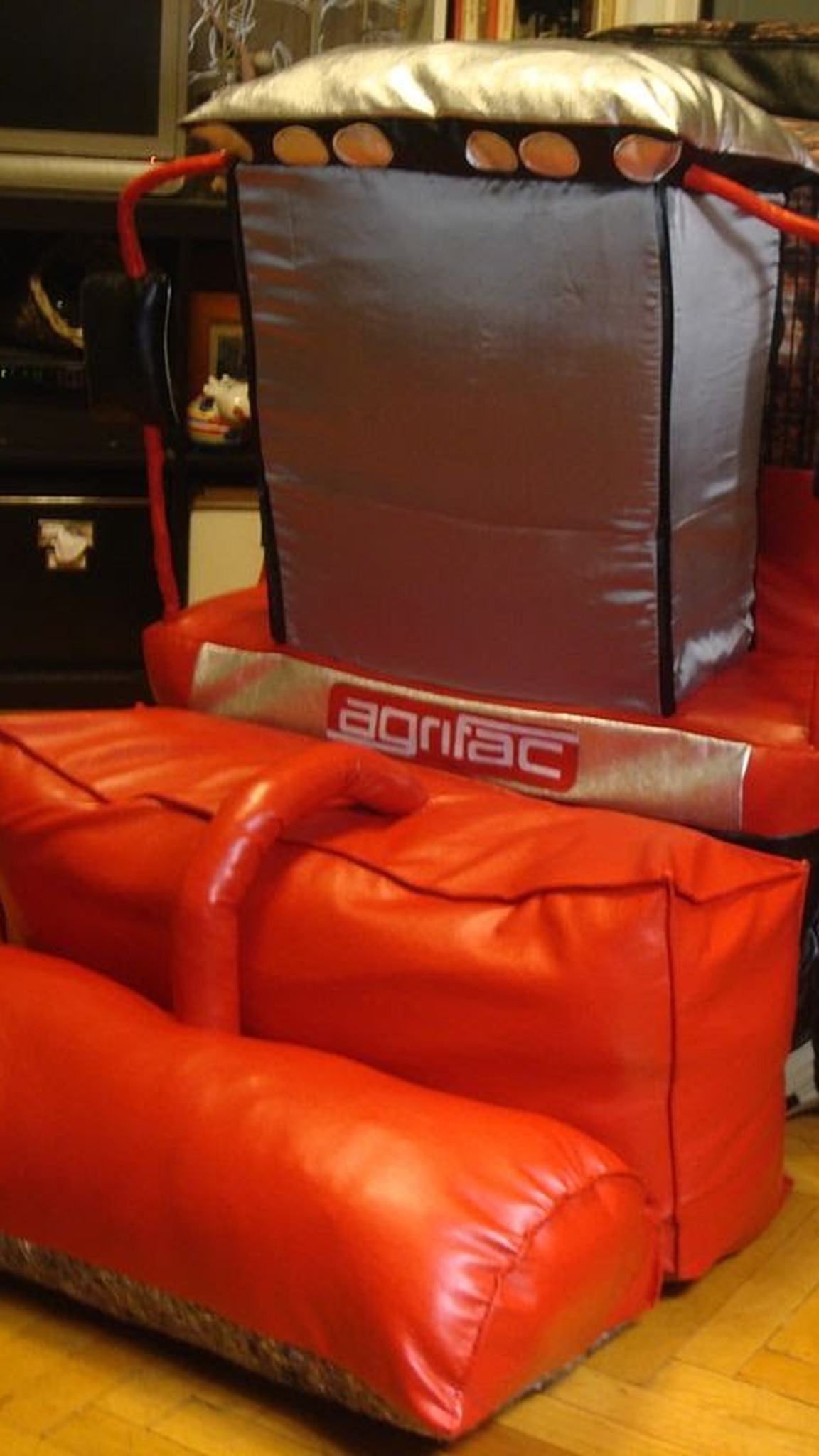 Soft red harvester model in glossy faux leather with mirrors and a red pipe, sewn by hand to order
