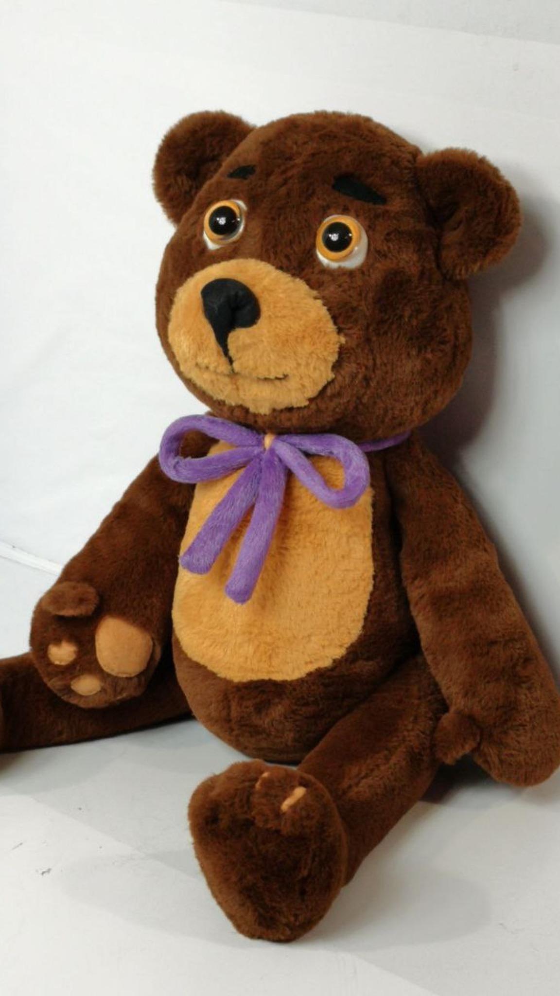 Sonya's teddy bear plush sitting, handmade to order: tan paw pads, orange eyes, purple bow, brown faux fur