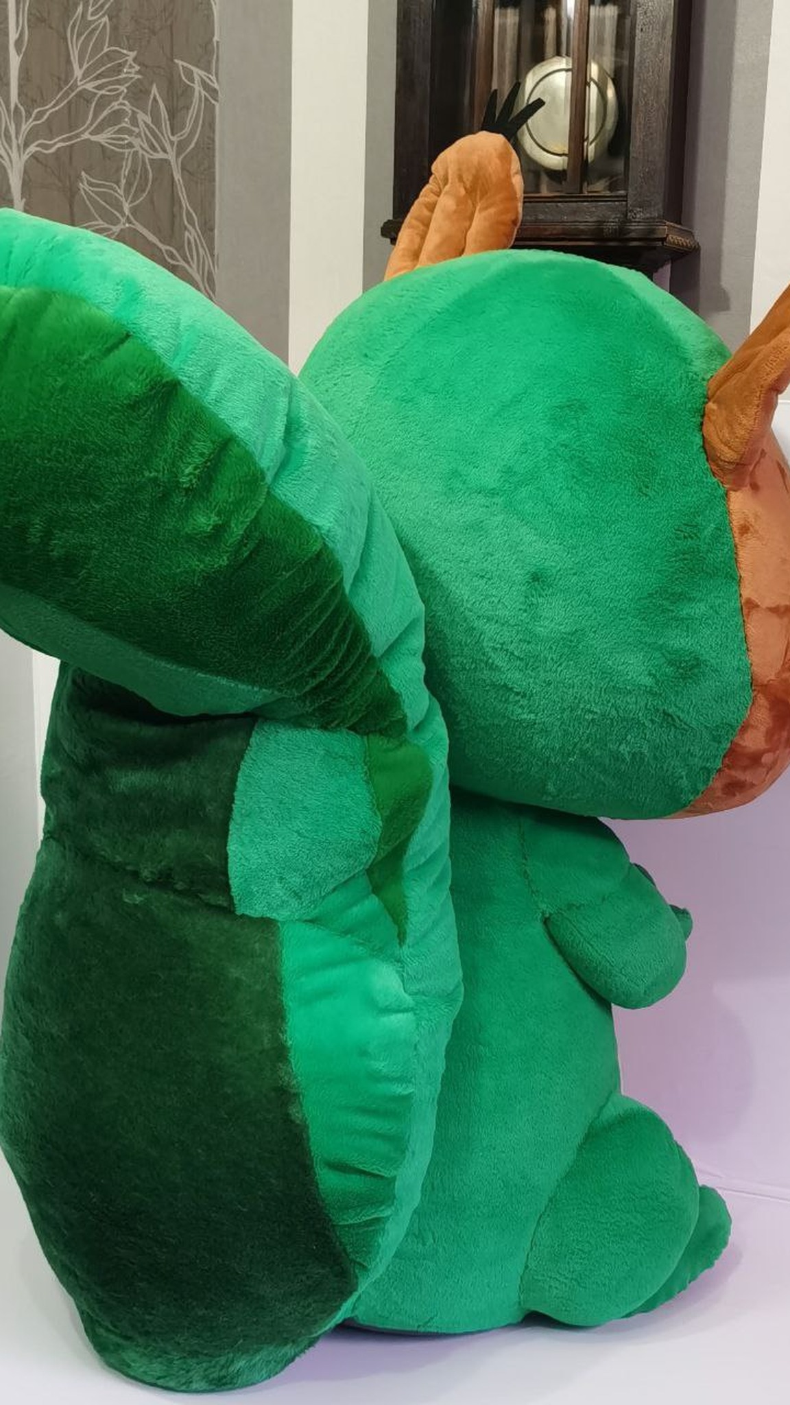 Big curled green tail of a squirrel mascot plush, sewn by hand to order for a trade show