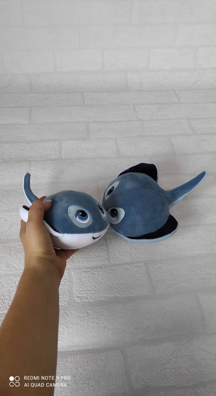 Stingray mascot plush in hand, made to order Hand holding a middle-size stingray mascot plush beside another ray, grey-blue, white belly, made to order