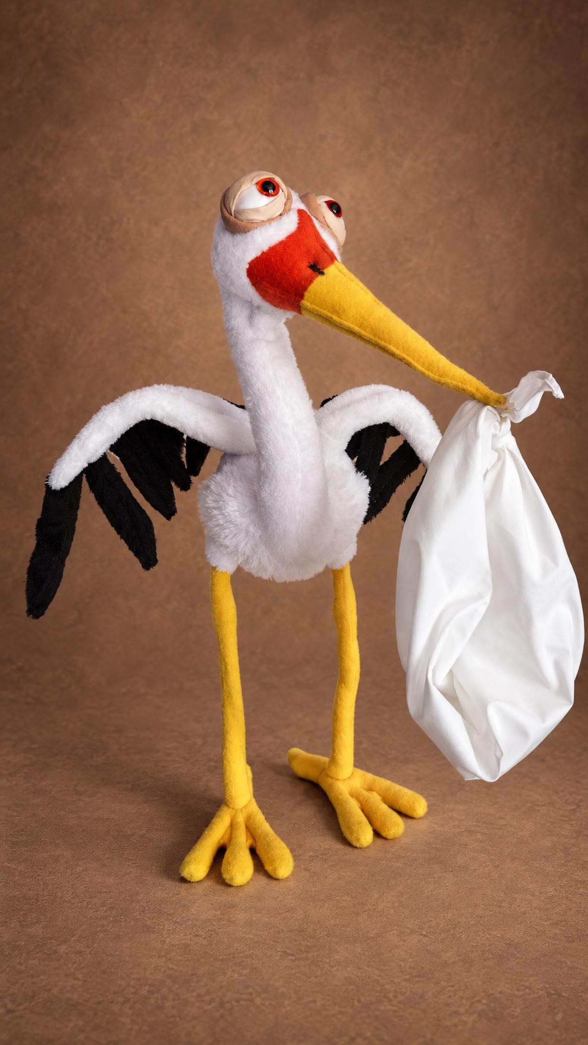 Custom stork plush in white faux fur with big rolling eyes and a baby bundle, handmade to order