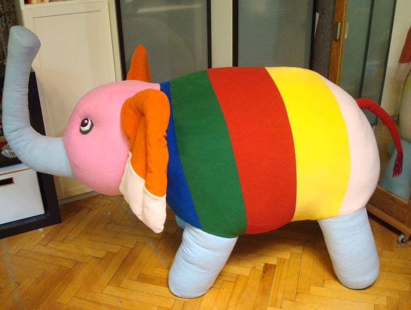 Striped elephant stuffed animal with a tassel tail Striped elephant stuffed animal with a red tassel tail and light blue legs, sewn to order from a kid's drawing