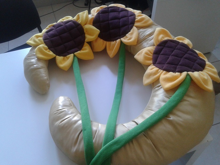 Sunflower cushions on a gold moon prop Three sunflower cushions with quilted brown centers lying on a gold moon photo prop, sewn to order