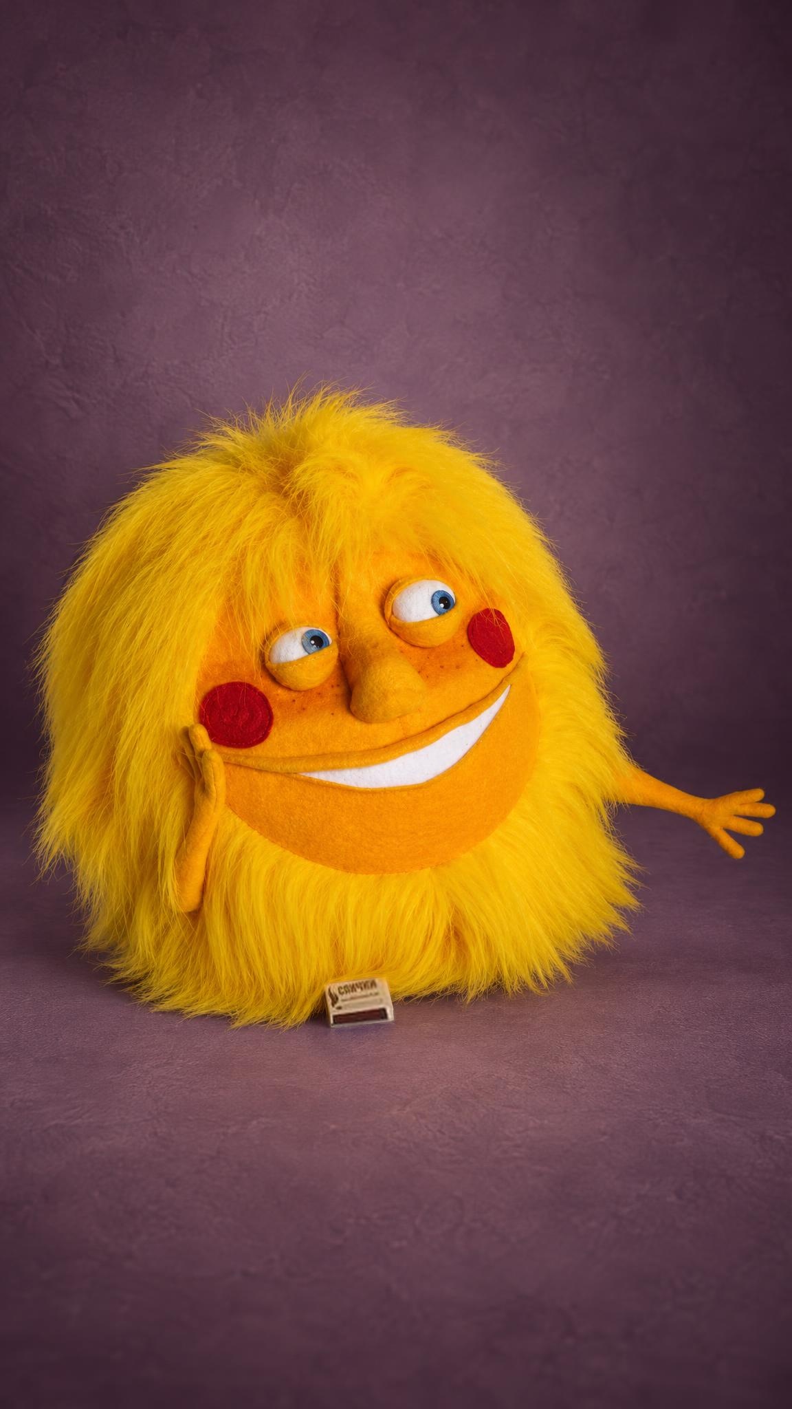 Sunshine plush pillow sewn to order: fluffy yellow faux fur, freckled orange face, wide smile, waving hand