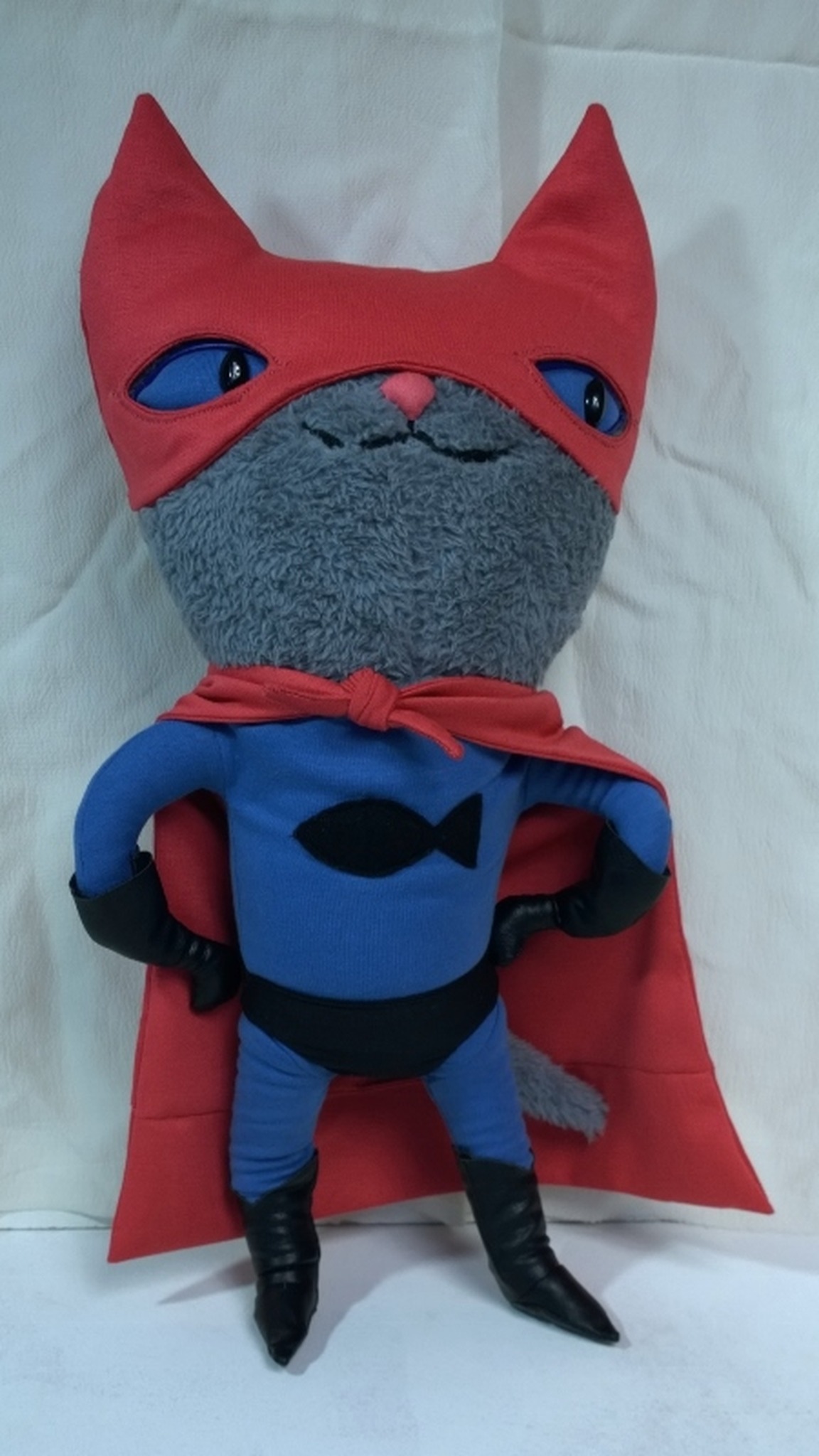 Superhero cat plush with a black fish emblem, red mask and cape, a custom cat plush handmade to order