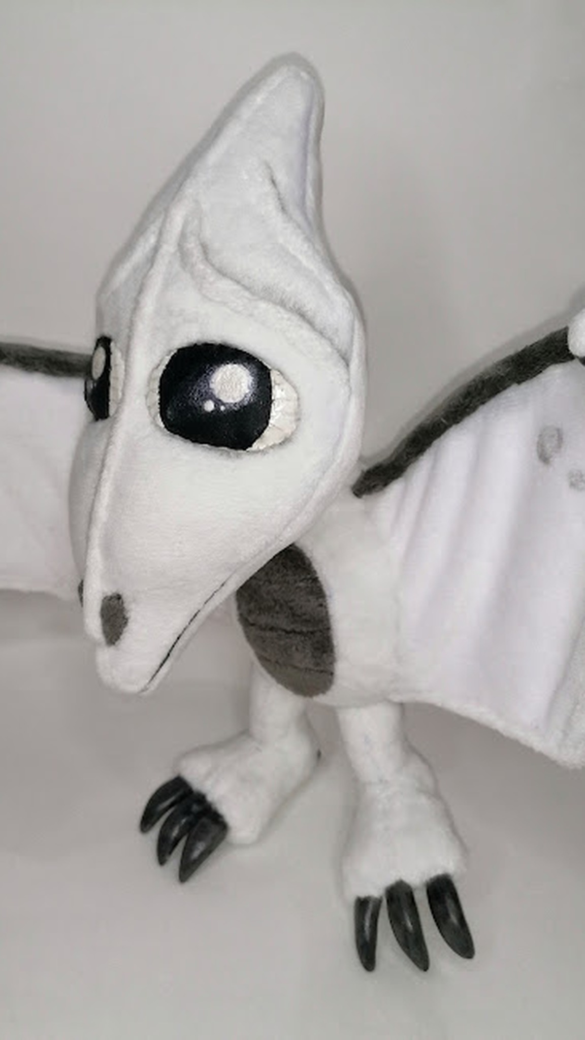 Custom tamagotchi pet plush with glossy black eyes and black claws, handmade to order