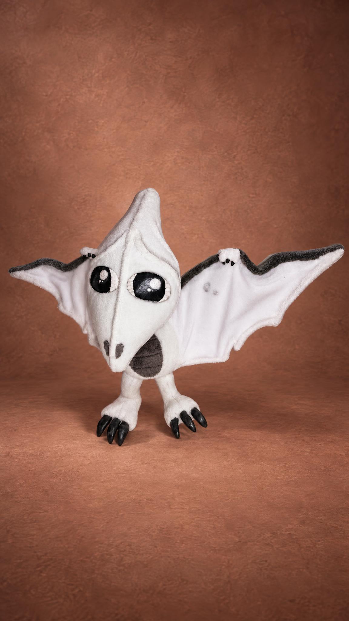 White tamagotchi pterodactyl plush with big black eyes and spread wings, sewn by hand to order