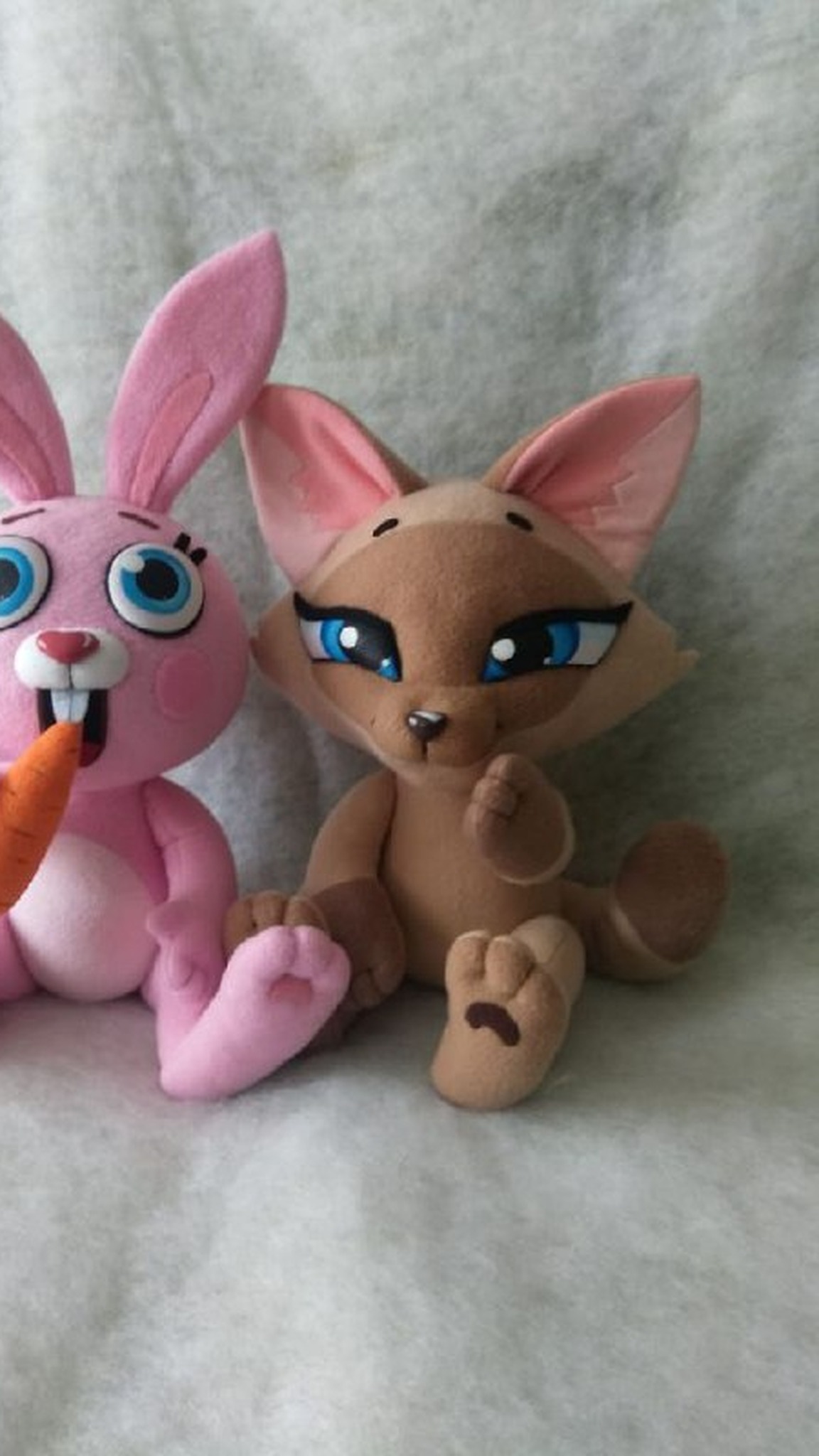 Tan fox sticker plush with a brown mask, lashes and one paw raised to her mouth, sewn to order