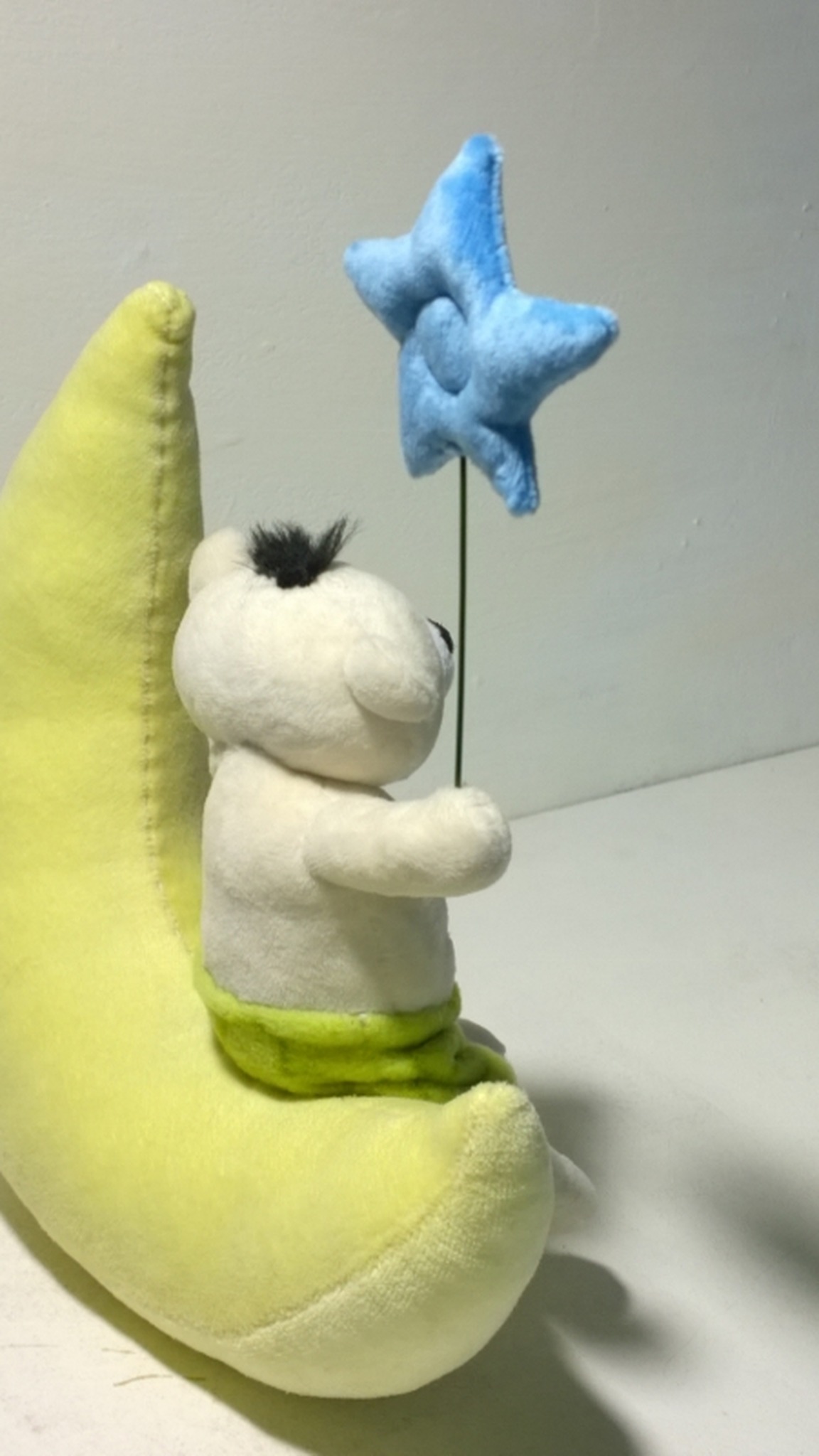 Teddy bear on a moon plush made to order: black faux fur tuft, green shorts, star held up on a thin stem