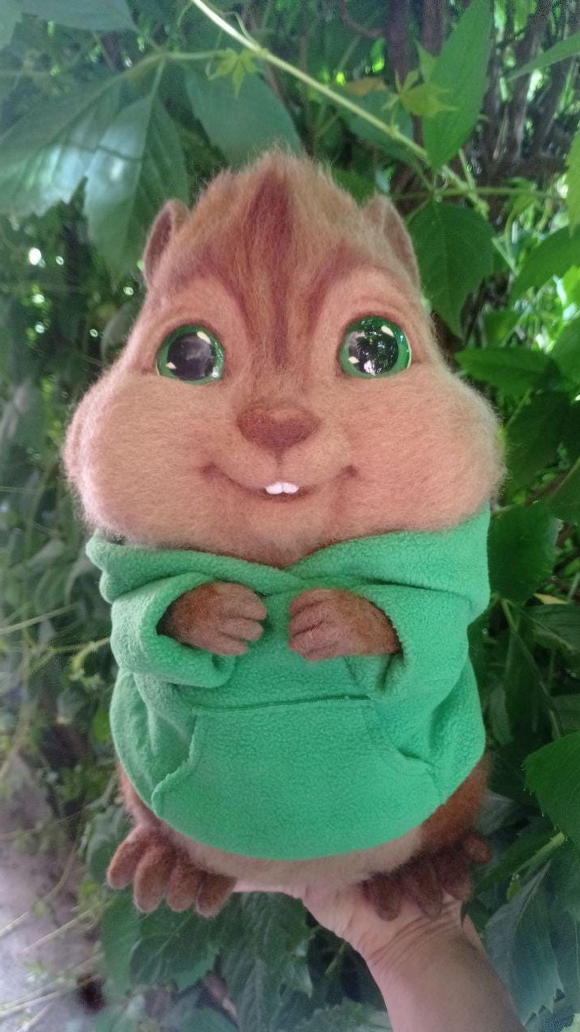 Theodore chipmunk plush held in a hand outdoors, green hoodie and wool fur, Alvin and the Chipmunks fan toy