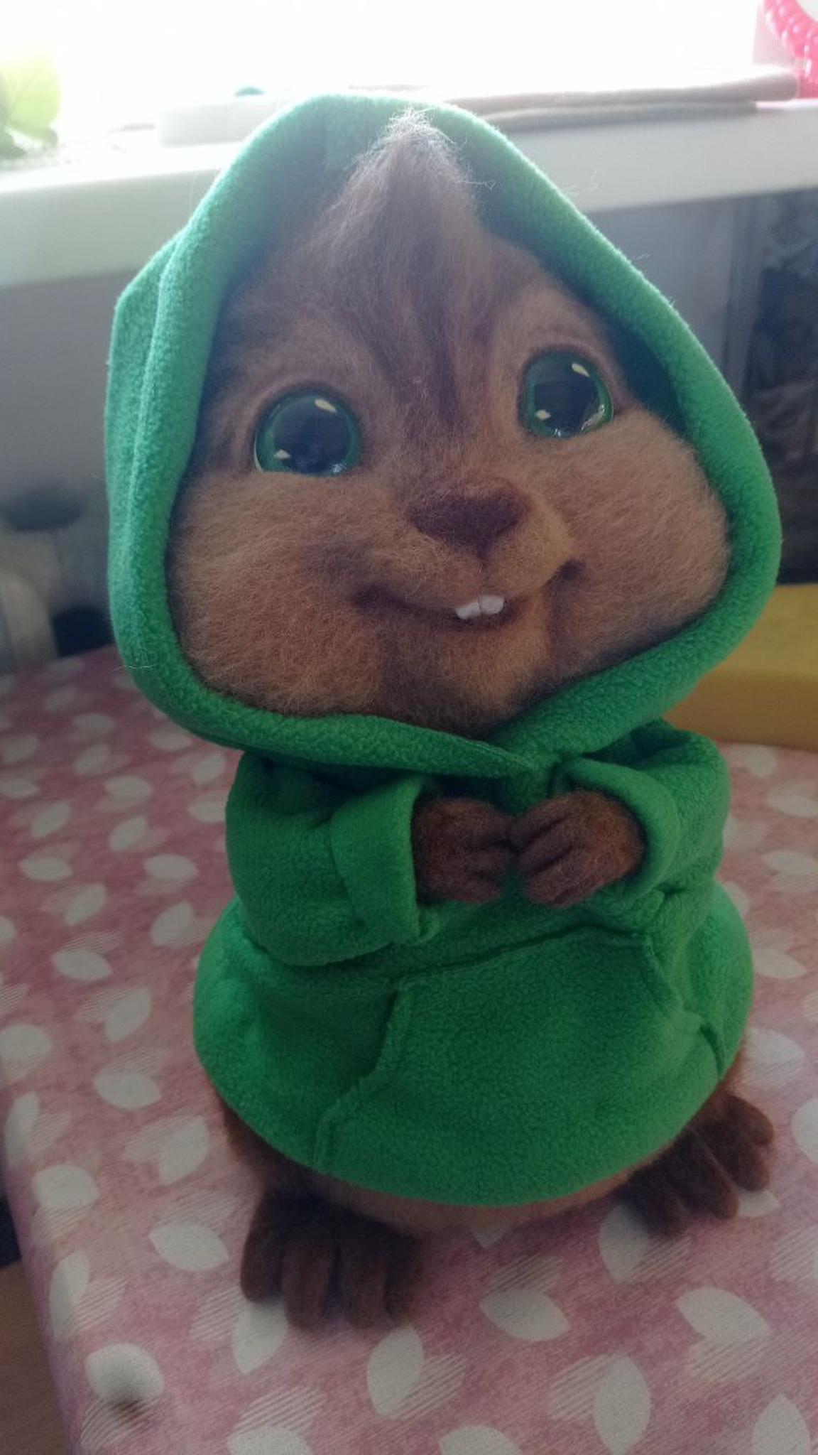 Felted Theodore chipmunk with a shy smile in his green hood, handmade wool toy from Alvin and the Chipmunks